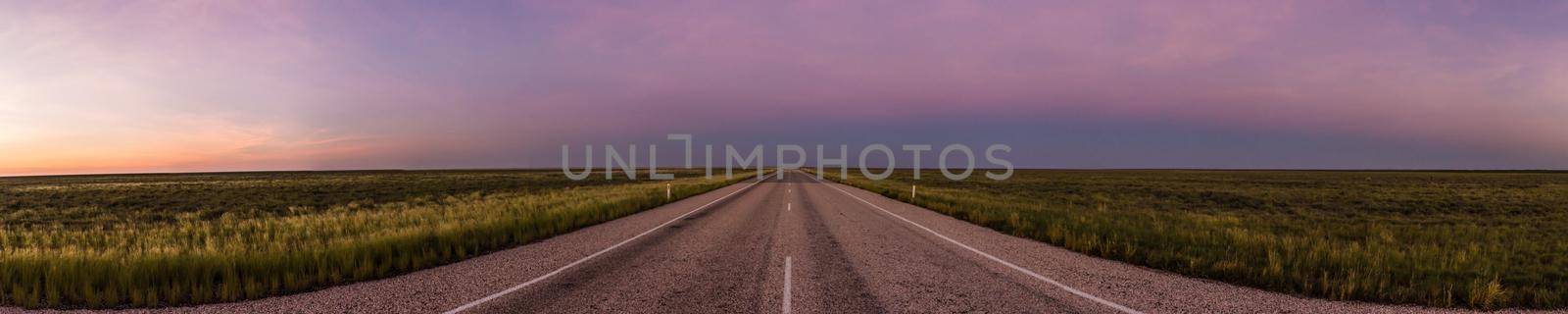 panorama of a straight road through the outback of Australia, after a beautiful sunset, Nothern territory by bettercallcurry