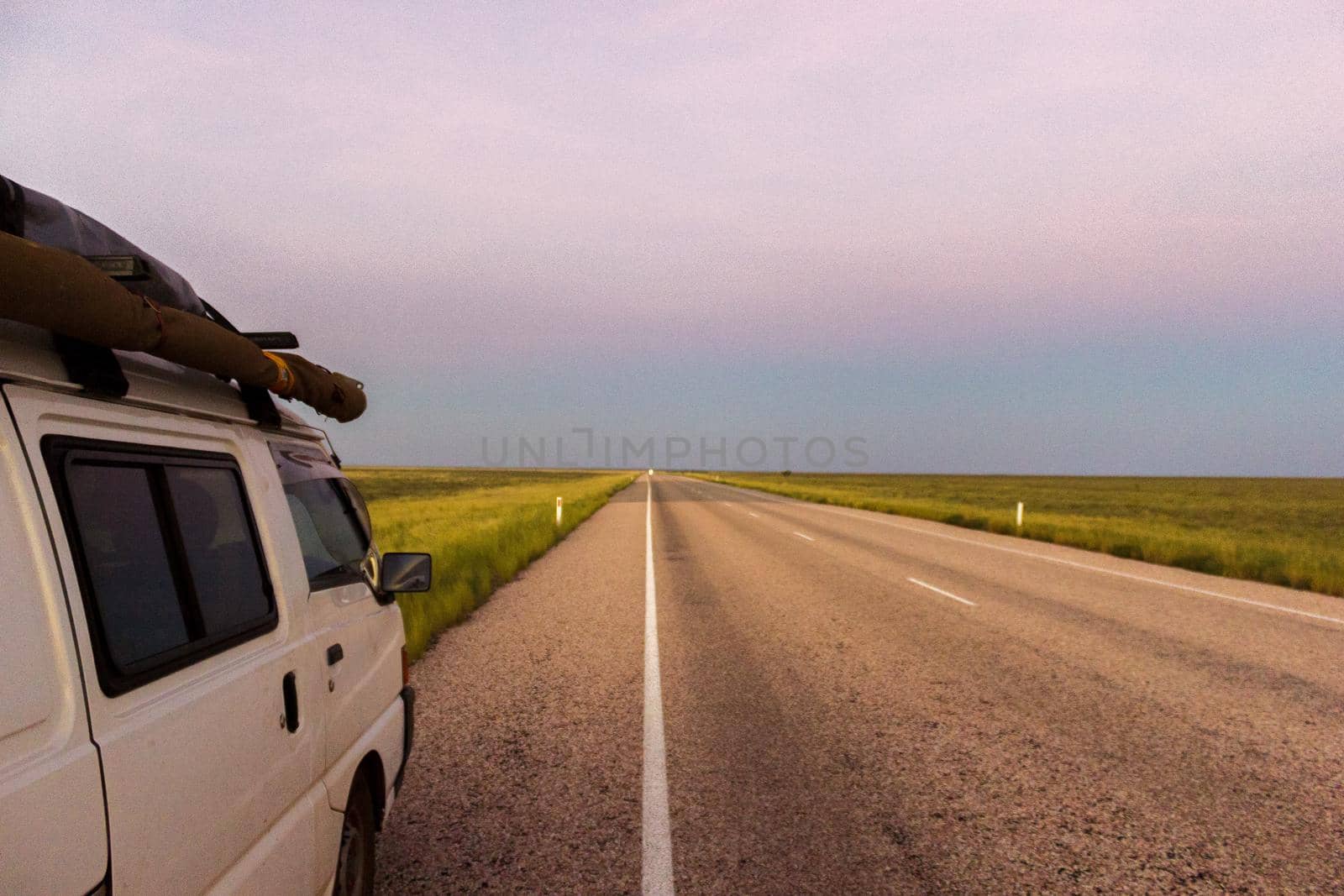 straight road through the outback of Australia, after a beautiful sunset