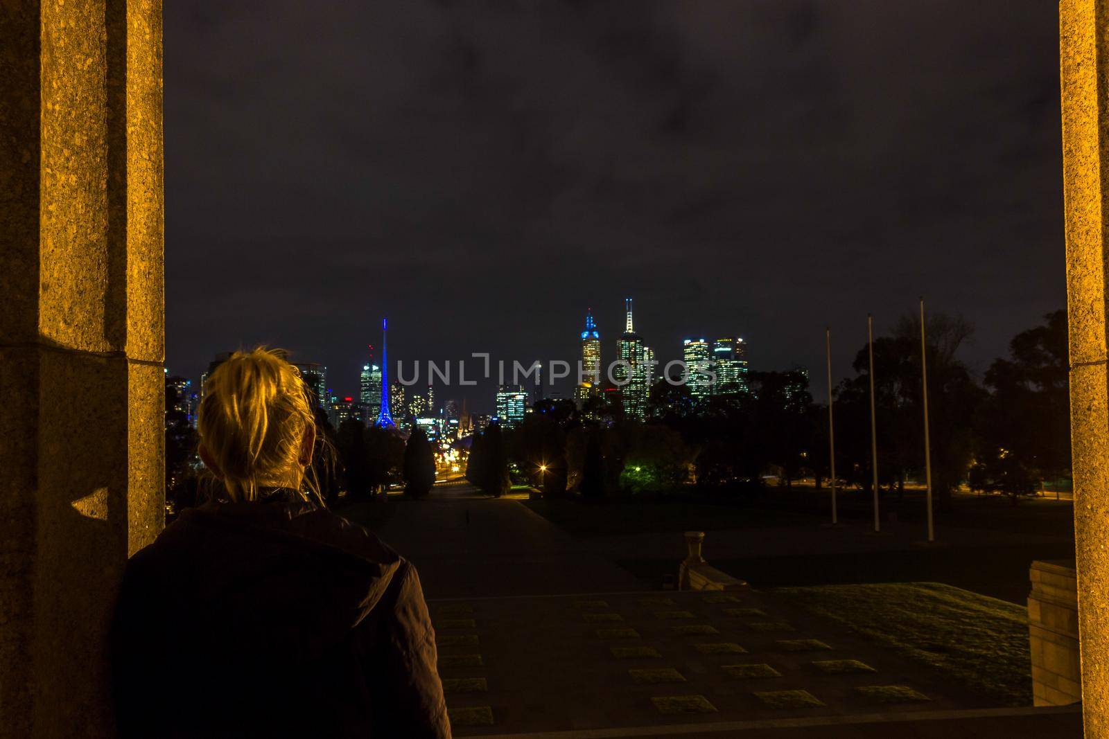 MELRBOURNE, Australia - May 2015. young women enyoing view over city skyline at night by bettercallcurry