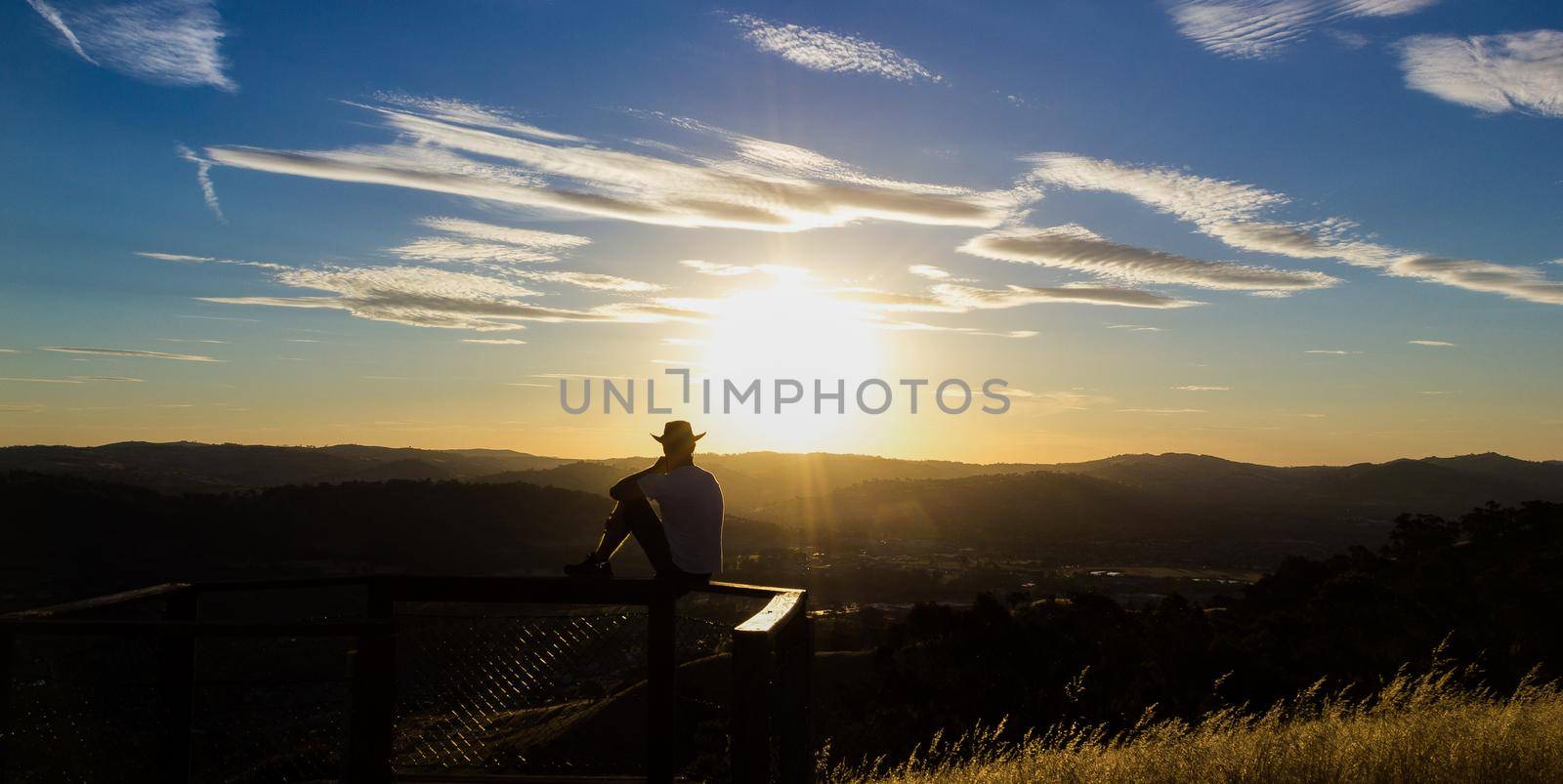 Young man is looking at the sunset, Albury, New South Wales, Australia