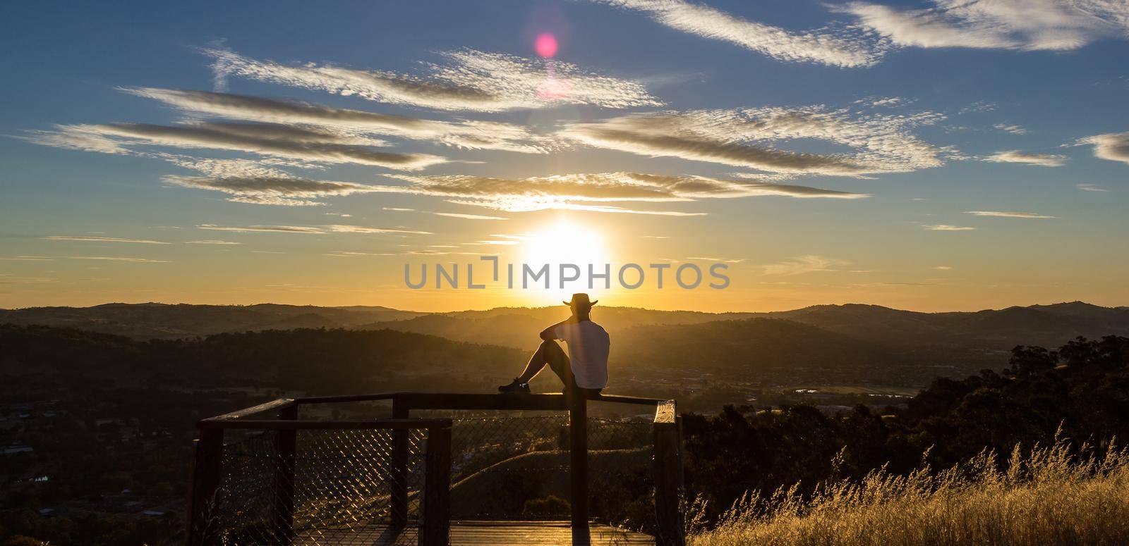 Young man is looking at the sunset, Albury, New South Wales, Australia