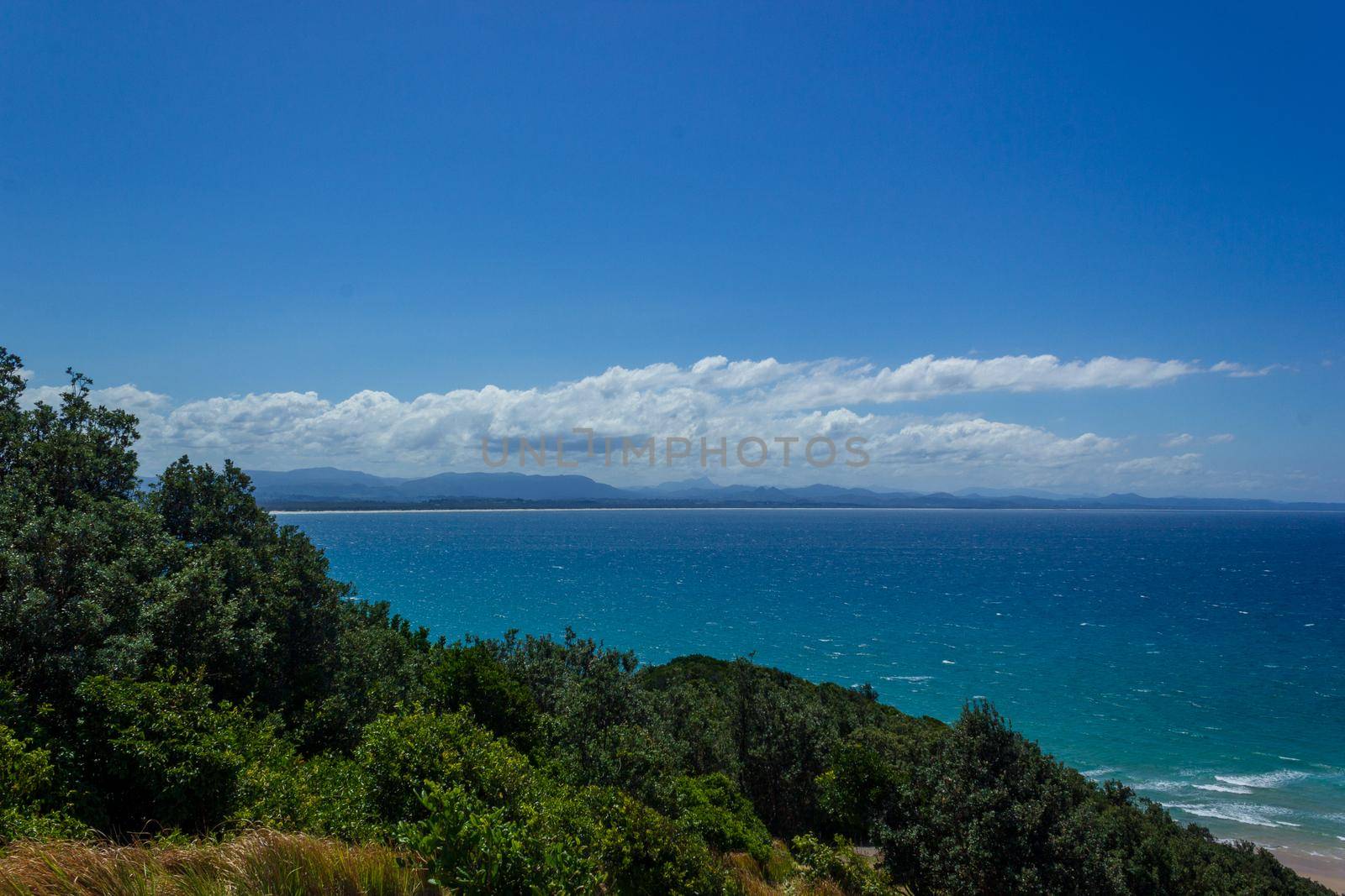 Clear water at the Pass on a sunny day in Byron Bay, Queensland, Australia by bettercallcurry