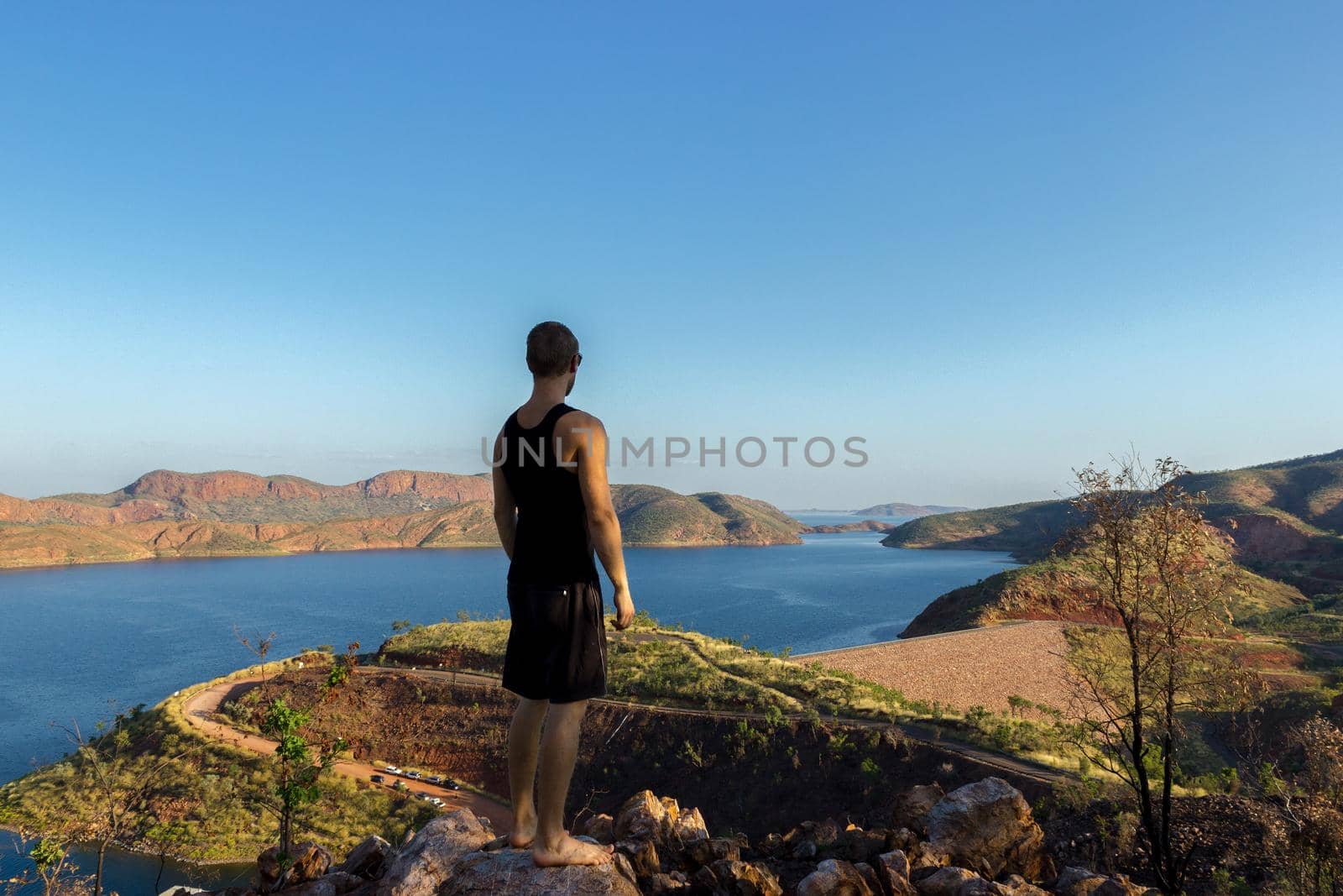 young man enyoing view over Lake Argyle. Western Australia's largest man-made reservoir by volume. near the East Kimberley town of Ku by bettercallcurry