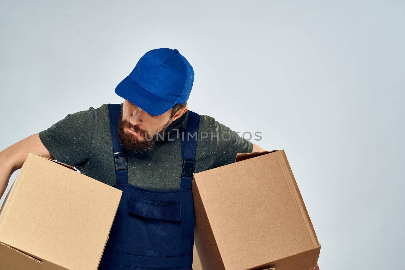 man in working uniform boxes delivery loading service. High quality photo