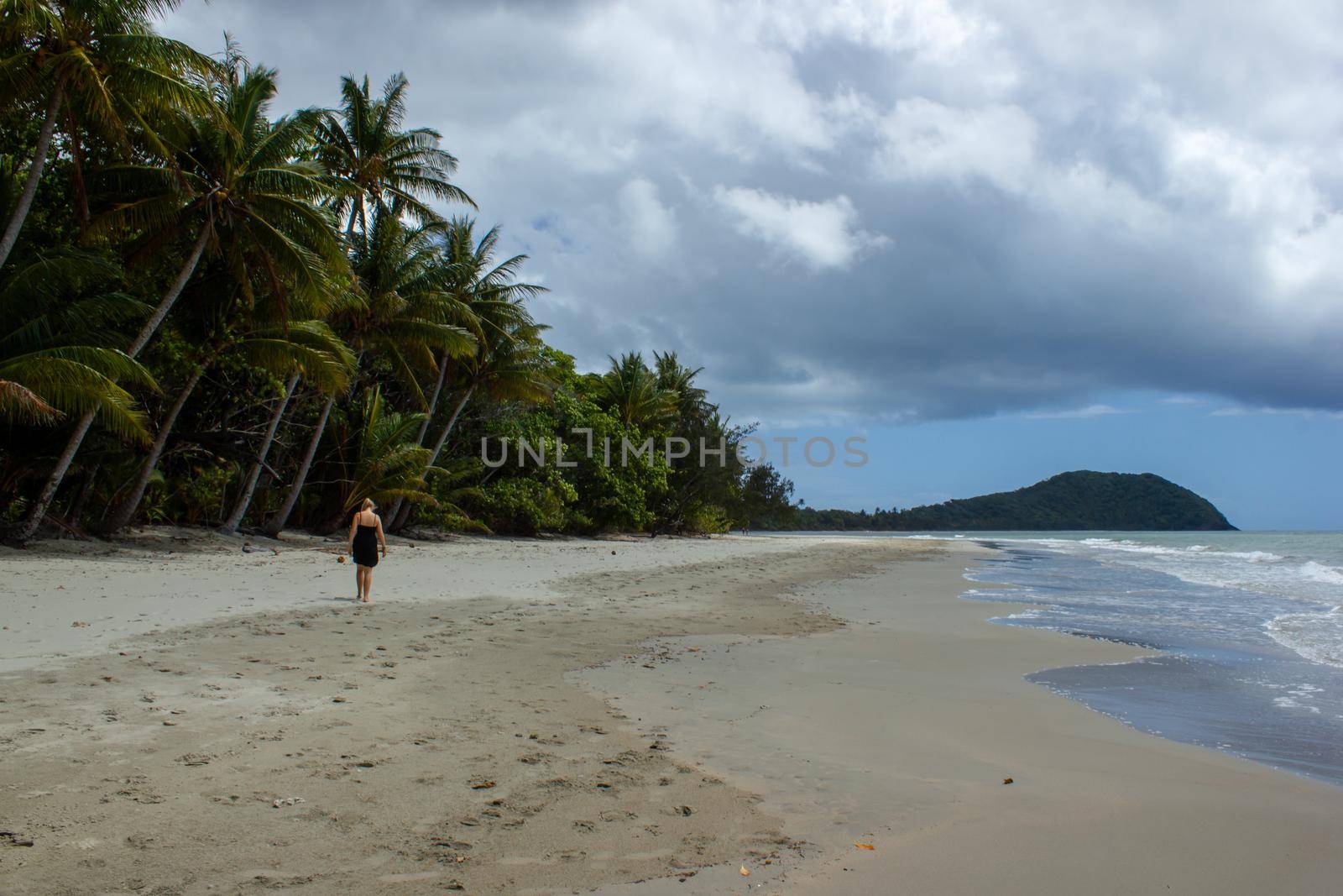 young women walking on the beach in Cape Tribulation in Daintree National Park in the far tropical north of Queensland, Australia by bettercallcurry