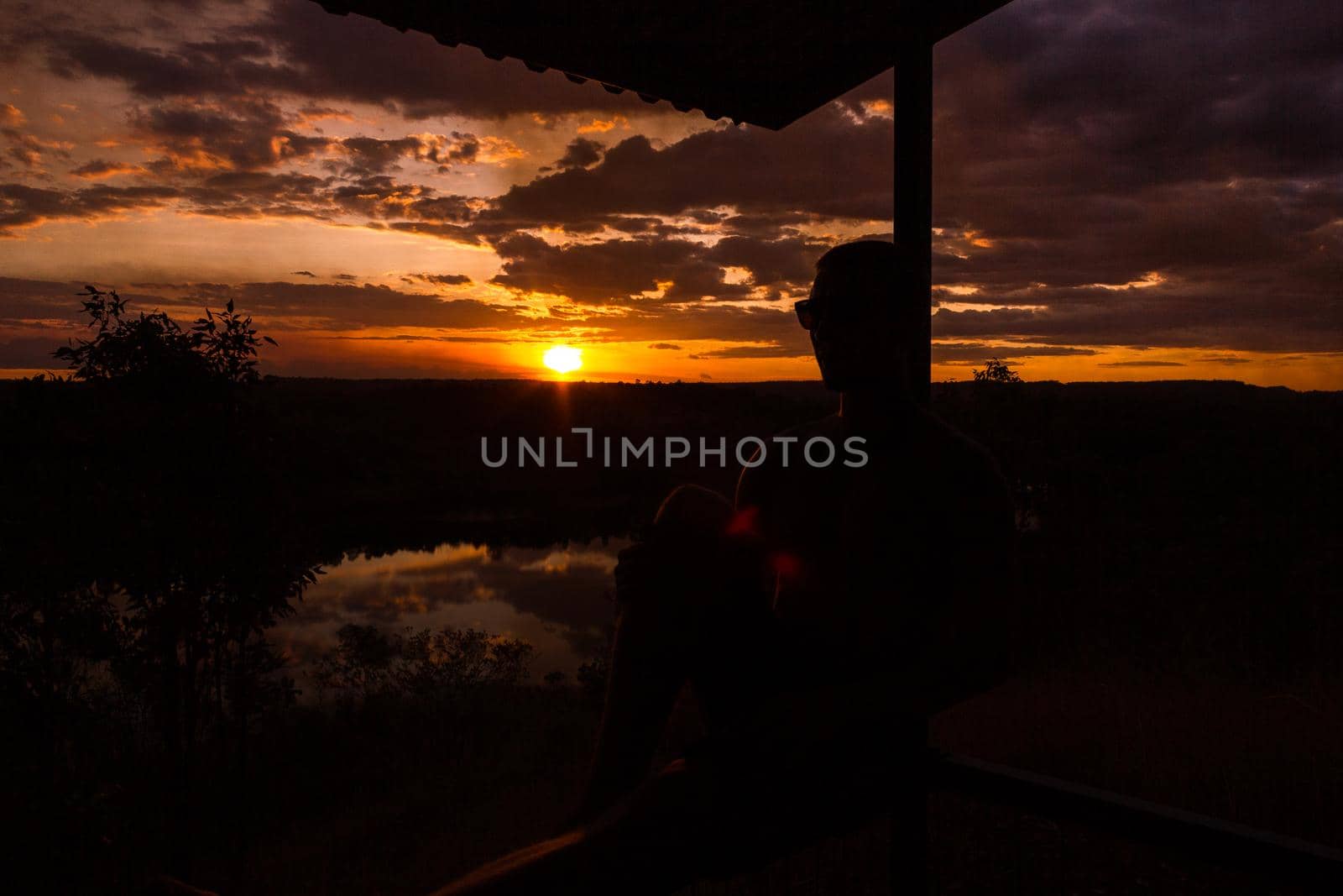 jung man enjoying beautiful sunset in the australian outback with 3 lakes, Nitmiluk National Park