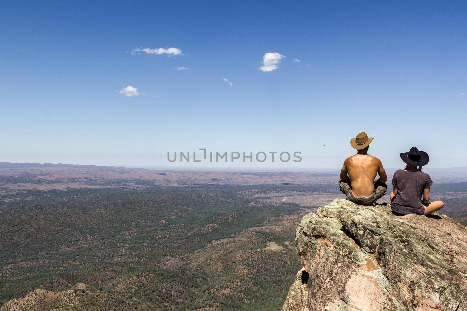 jung women and men sitting on St Mary's Peak from the Flinders Ranges National Park by bettercallcurry