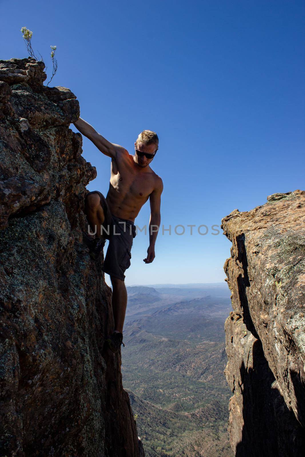 jung man standing between 2 rocks on St Mary's Peak from the Flinders Ranges National Park, Australia