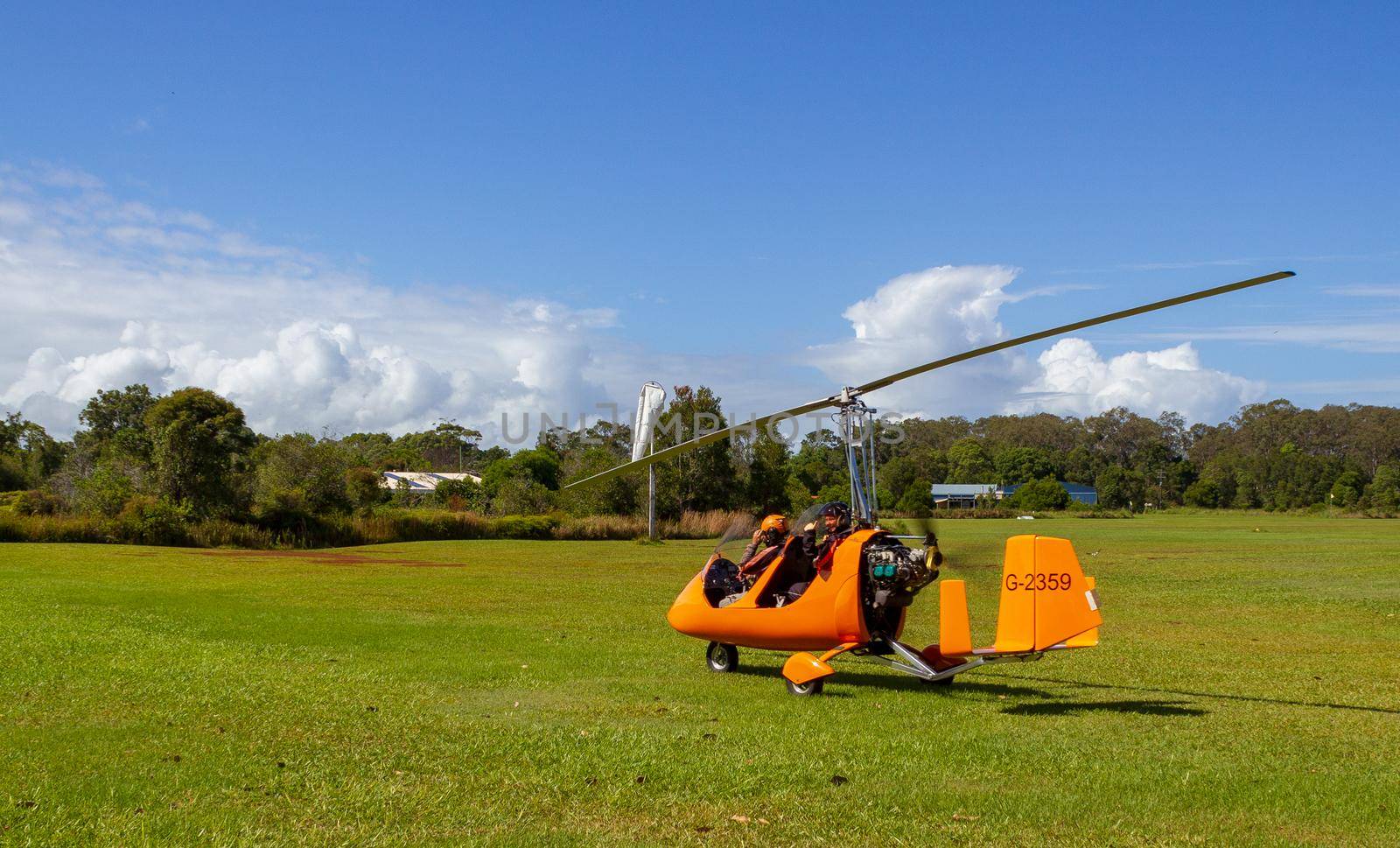 Takeoff of a gyrocopter on an grass airfield in Bayron Bay, Queensland, Australia by bettercallcurry