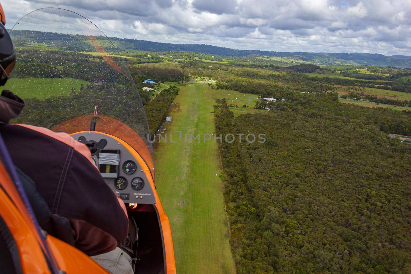 Gyrocopter is landing on an airfield out of gras, Byron Bay, Queensland, Australia by bettercallcurry