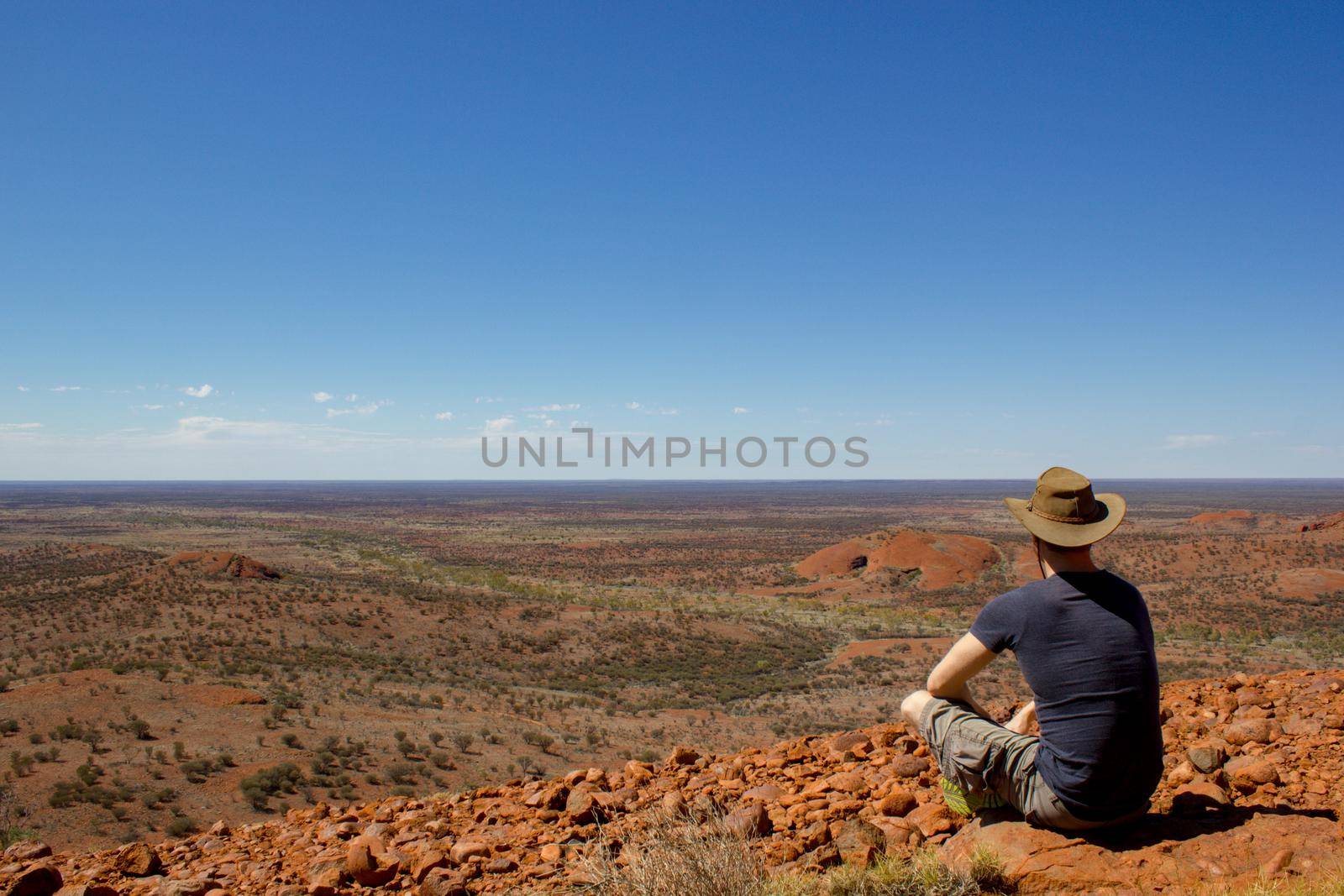 tourist enyoing view over the outback from a hill, after hiking up the olgas, the ,Red Center of Australia, Australia by bettercallcurry