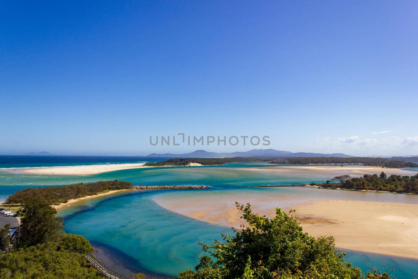 Flat sand dunes on the delta of the Nambucca River, which enters the Pacific Ocean through wide sandy beaches of the Australian coast around Nambucca Heads by bettercallcurry