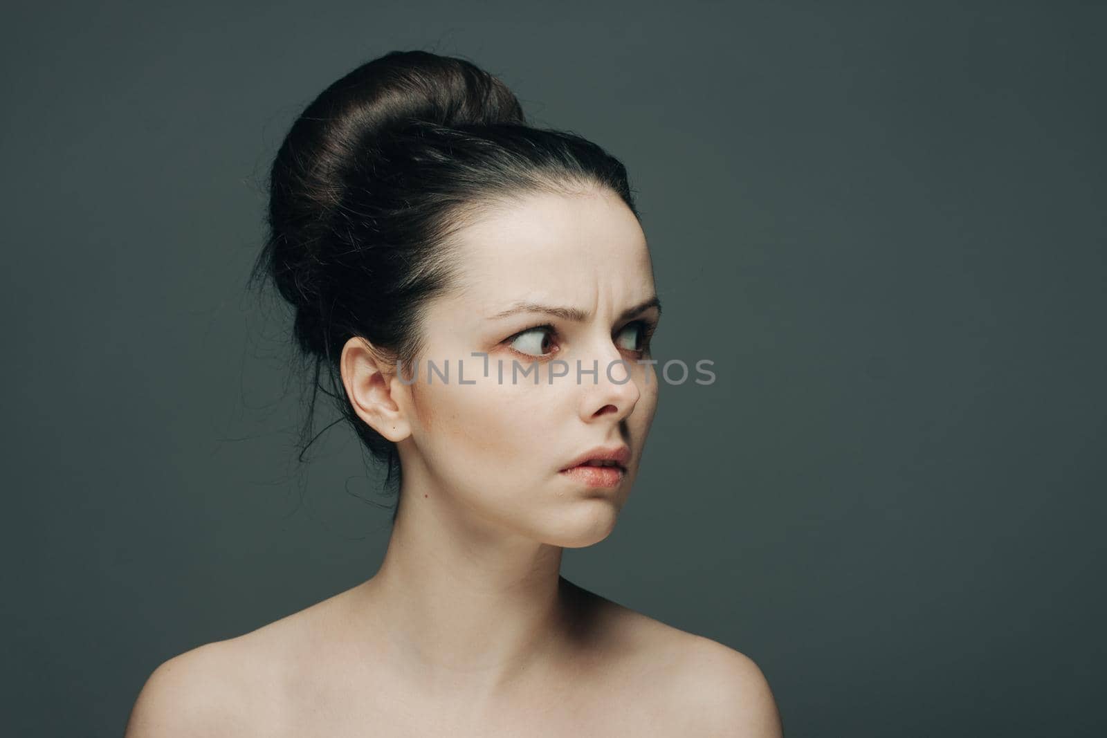 brunette with bare shoulders surprised look emotions clear skin. High quality photo