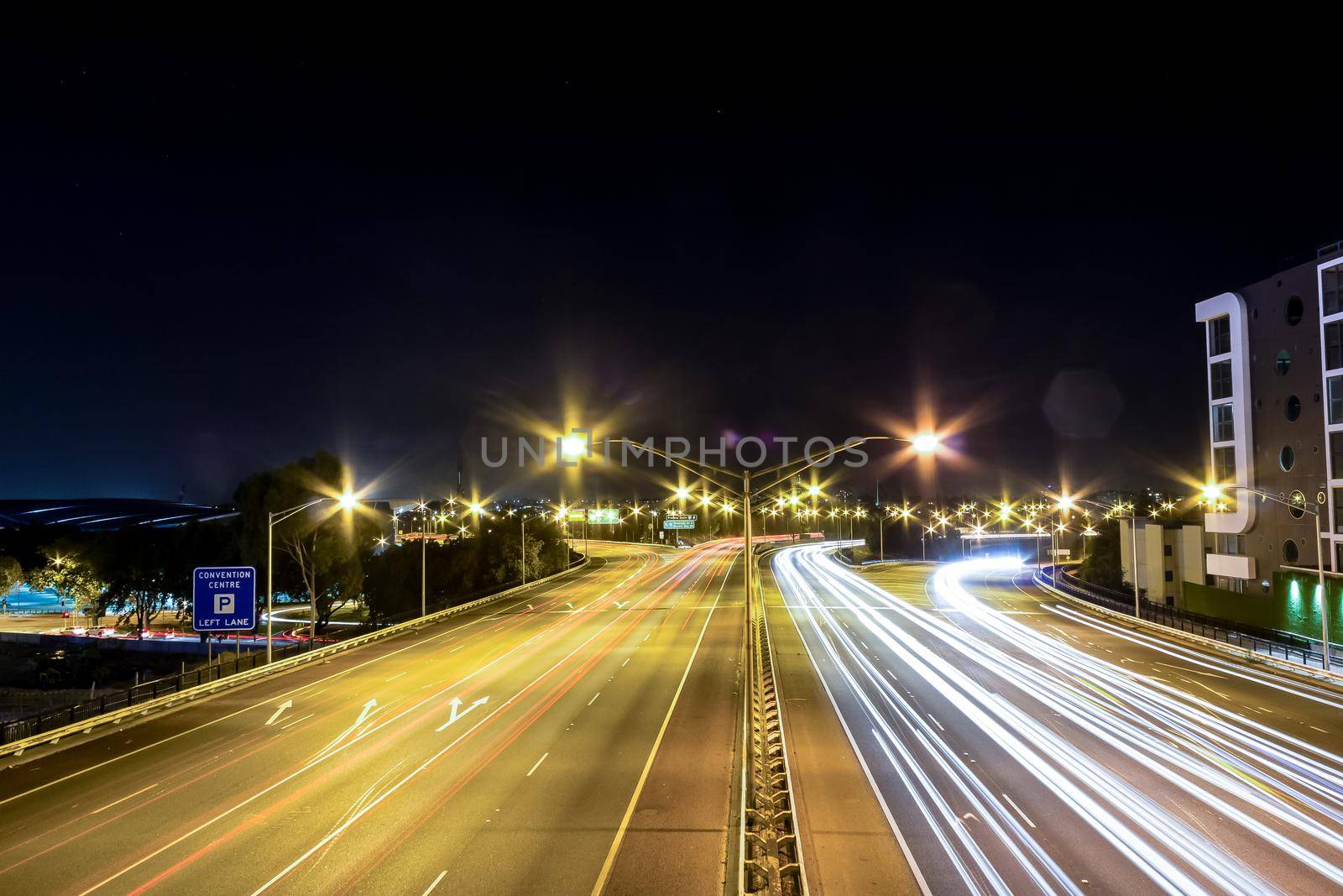 Traffic lights on city road during night in Perth, WA Australia.