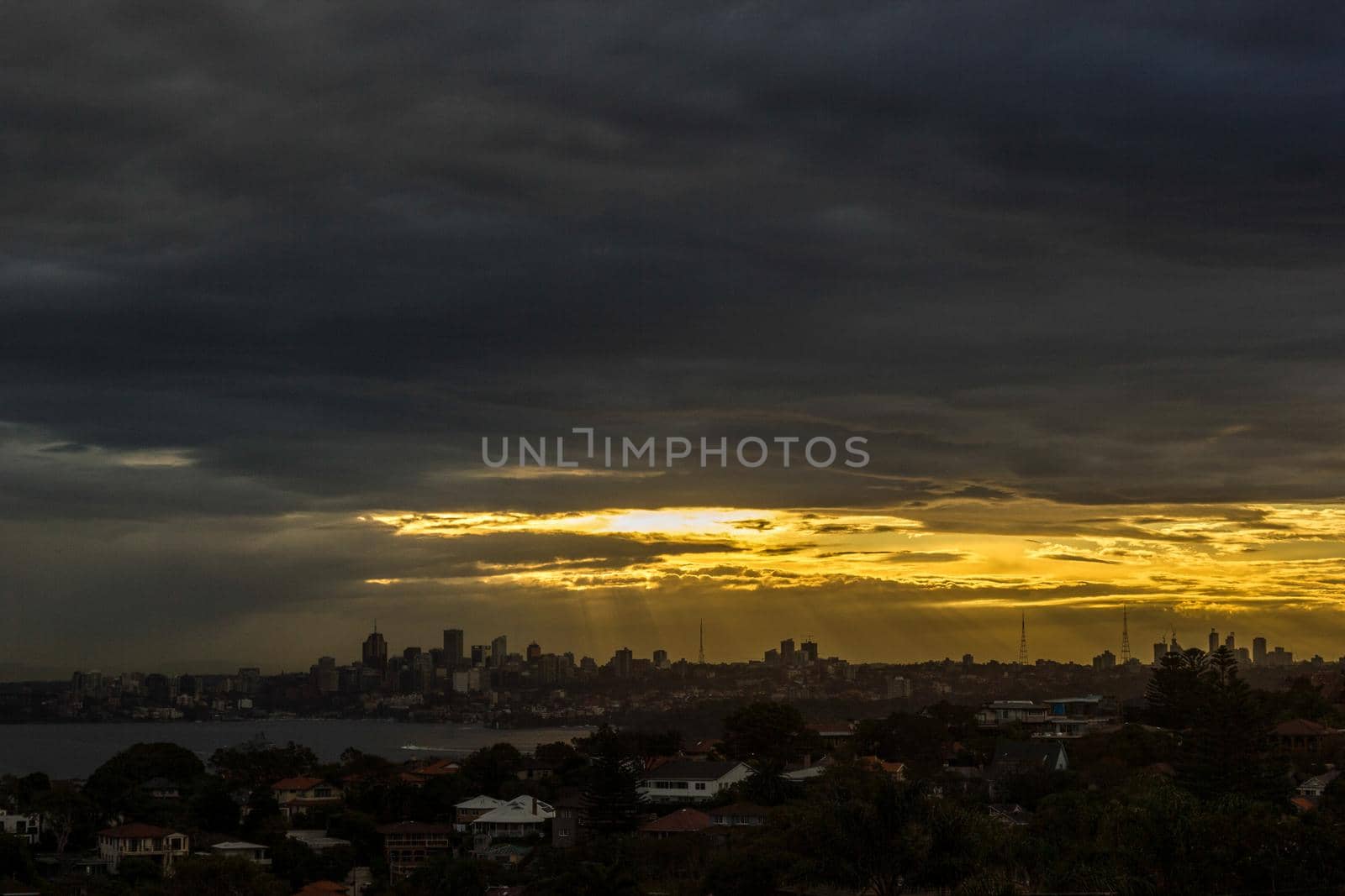 Sydney Panorama taken from a unique position at sunset, sunrays shining on the city, New South Wales, Australia