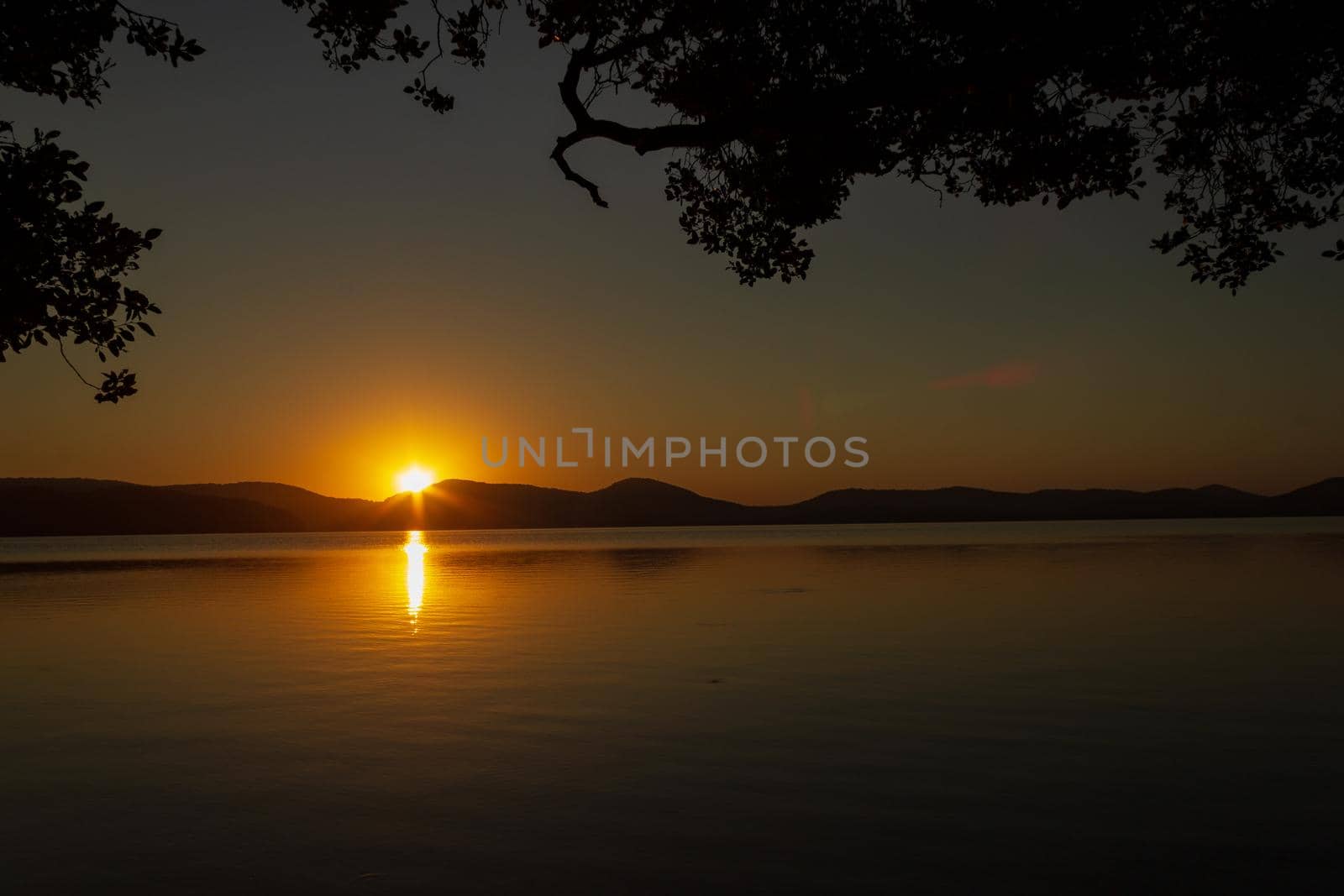 beautiful sunset over Watson Taylors Lake in Crowdy Bay National Park, New South Wales, Australia by bettercallcurry