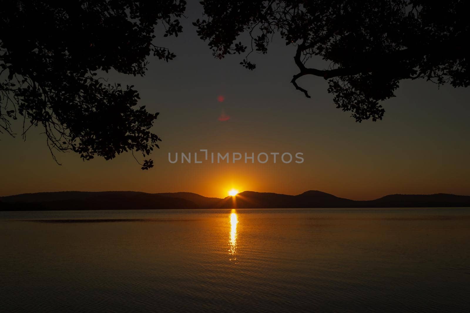 beautiful sunset over Watson Taylors Lake in Crowdy Bay National Park, New South Wales, Australia by bettercallcurry