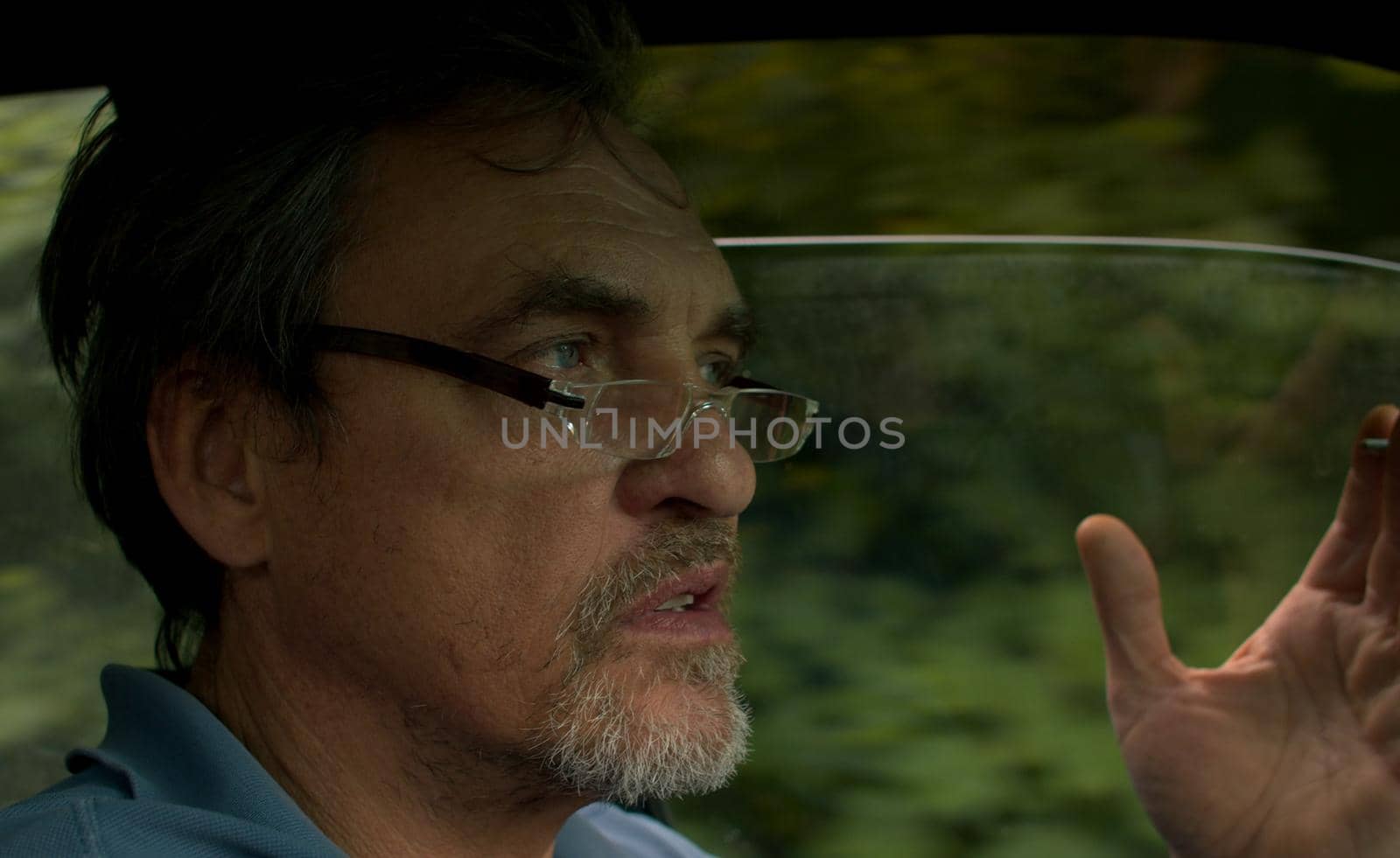 Portrait of senior man driving a car by Chudakov
