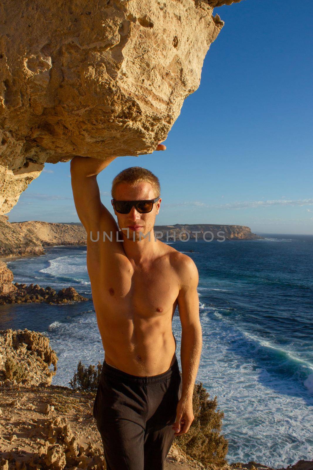 jung man standing on cliffs near port lincon at sunset, South Australia by bettercallcurry