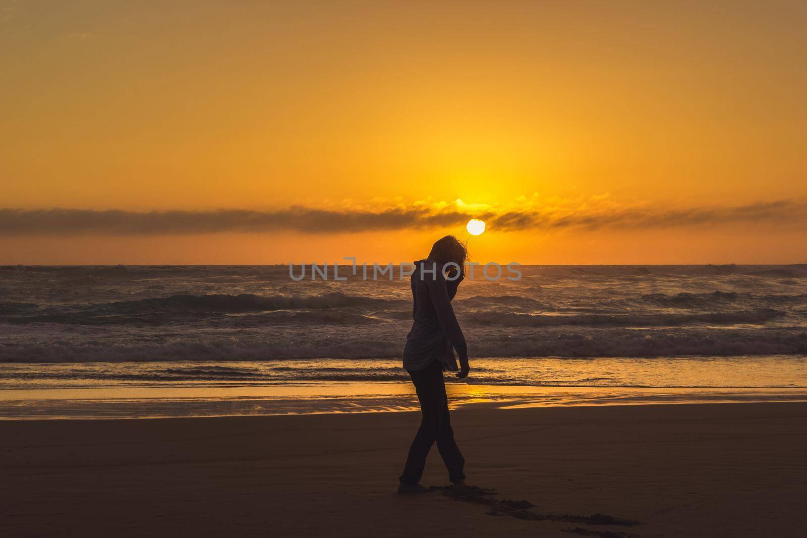 carefree woman dancing in the sunset on the beach. vacation vitality healthy living concept, Australia by bettercallcurry