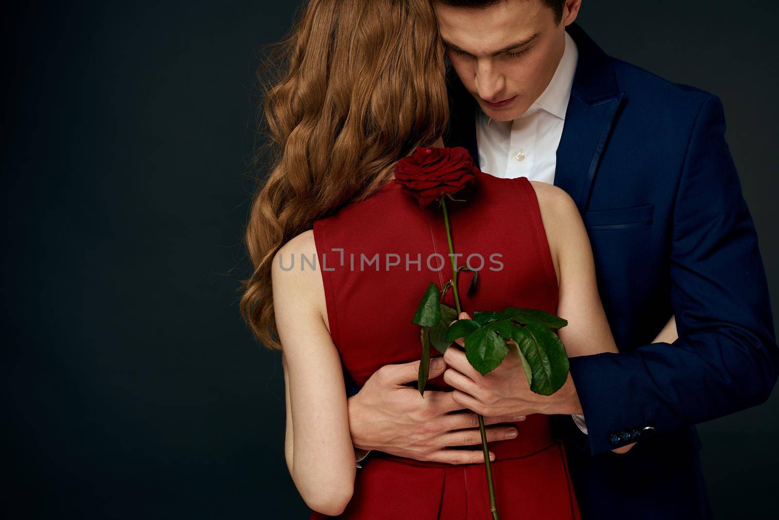 cute young couple romance dating hug luxury dark background by SHOTPRIME