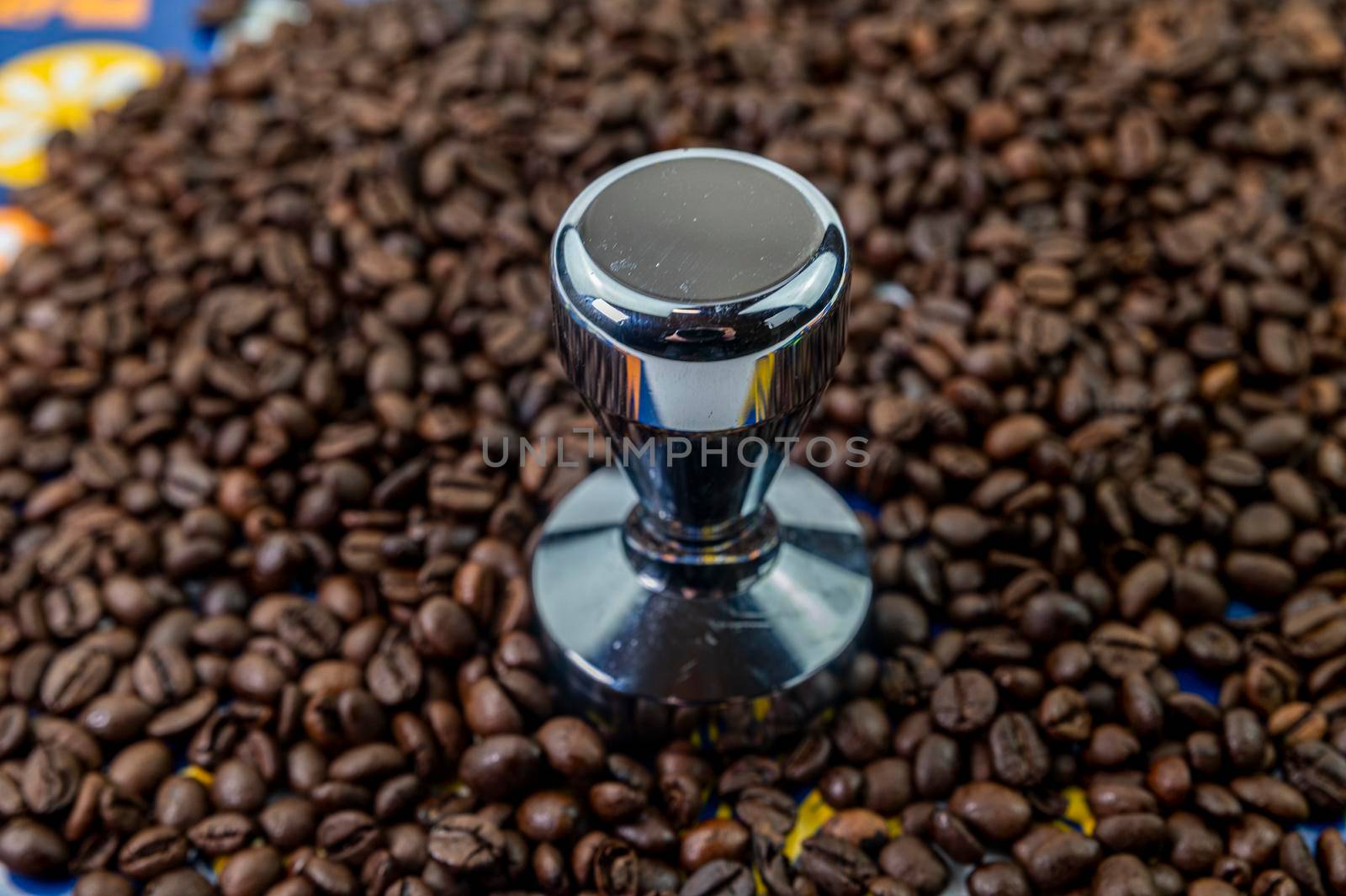coffee beans with steel coffee press for bars