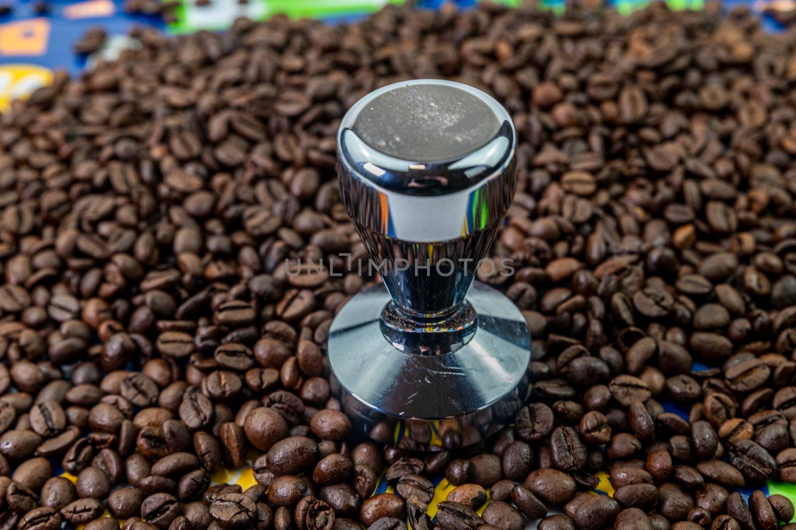 coffee beans with steel coffee press for bars