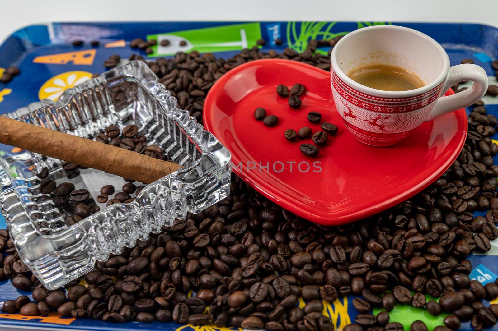composition of coffee beans with heart shaped cup and saucer with ashtray and cigar