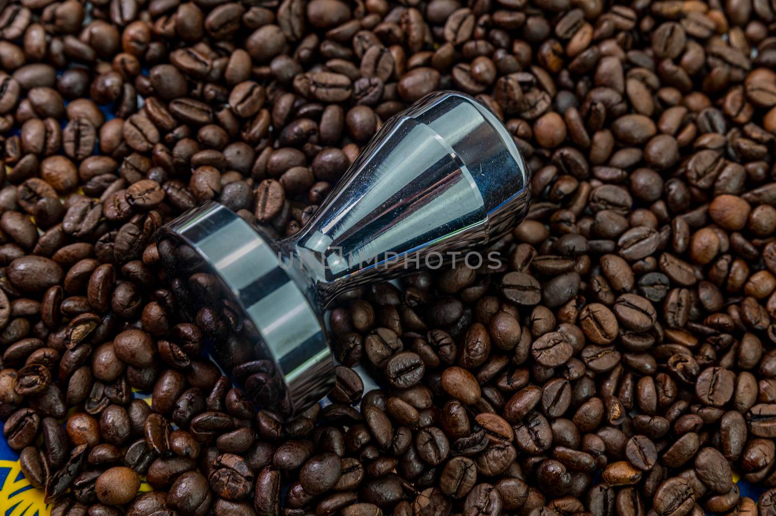 coffee beans with steel coffee press for bars