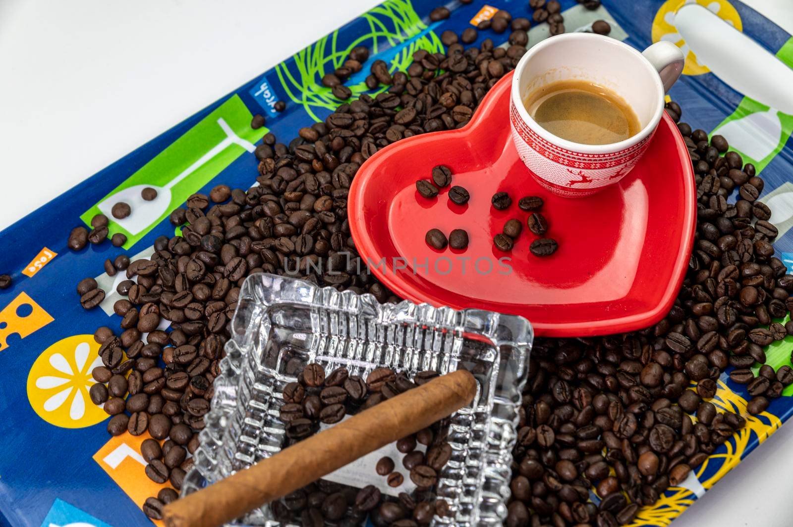 composition of coffee beans with heart shaped cup and saucer with ashtray and cigar