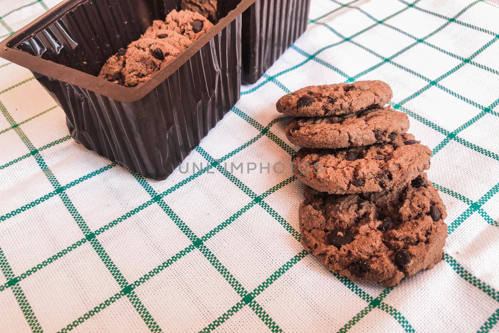 Chocolate cookies in packaging on cloth background.