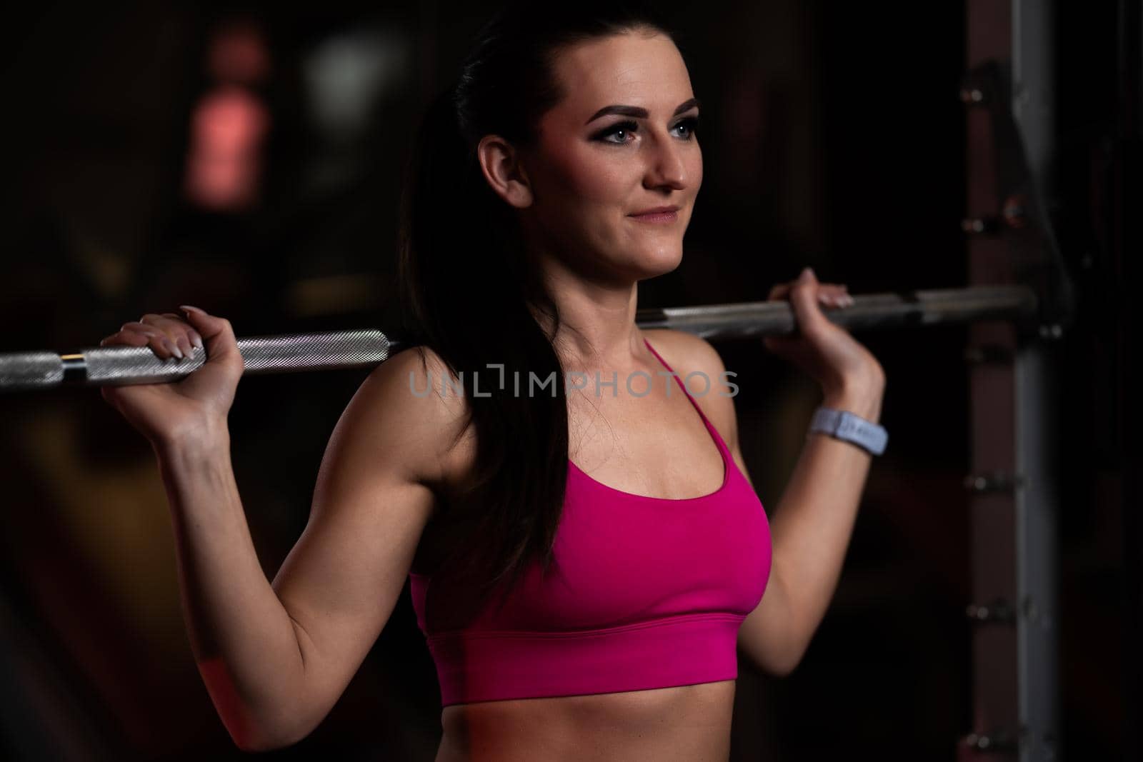 pretty young fitness woman at the gym on a fitness machine by Edophoto