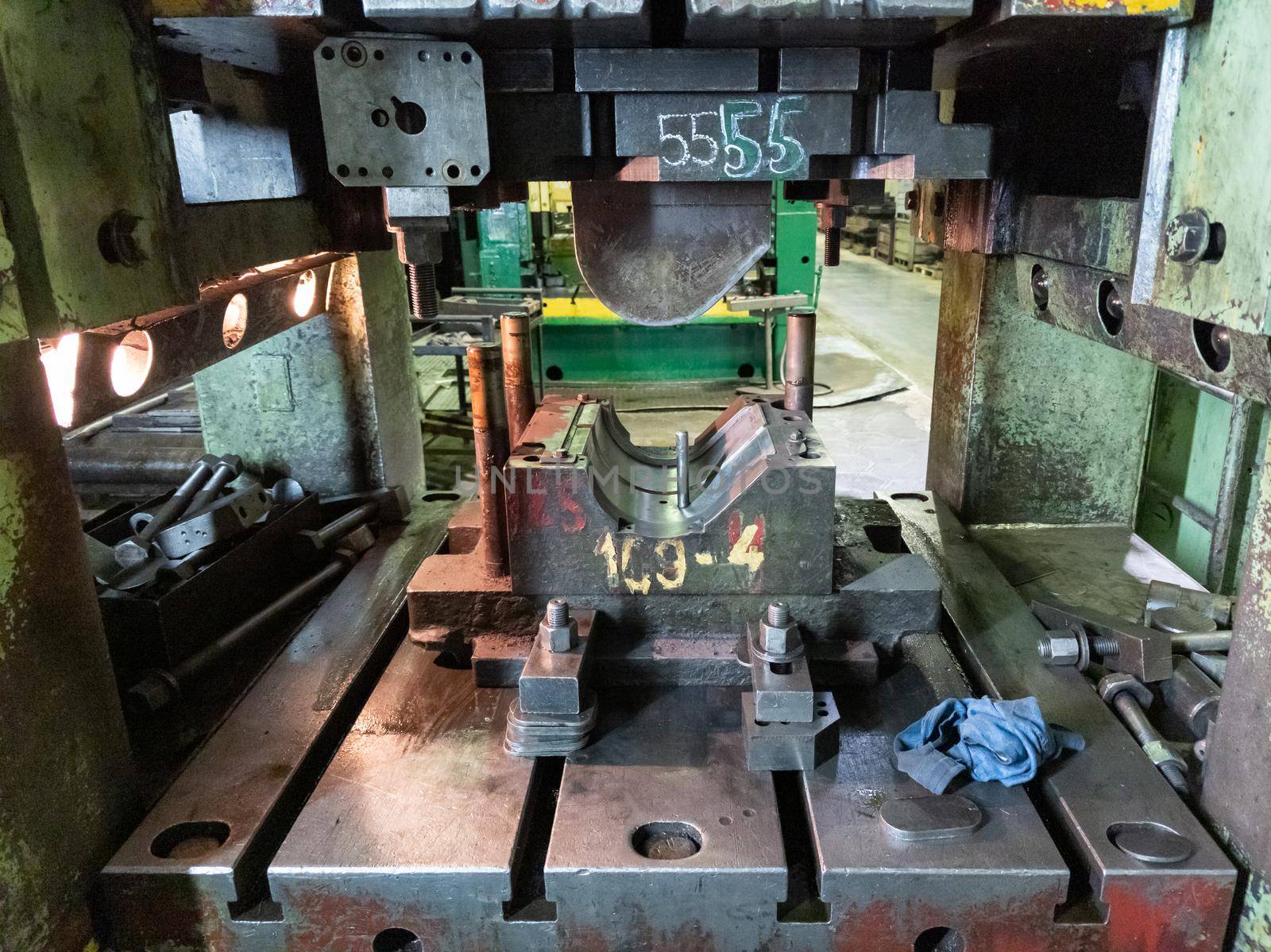dirty used low tech stamping press with sheet metal die tooling.