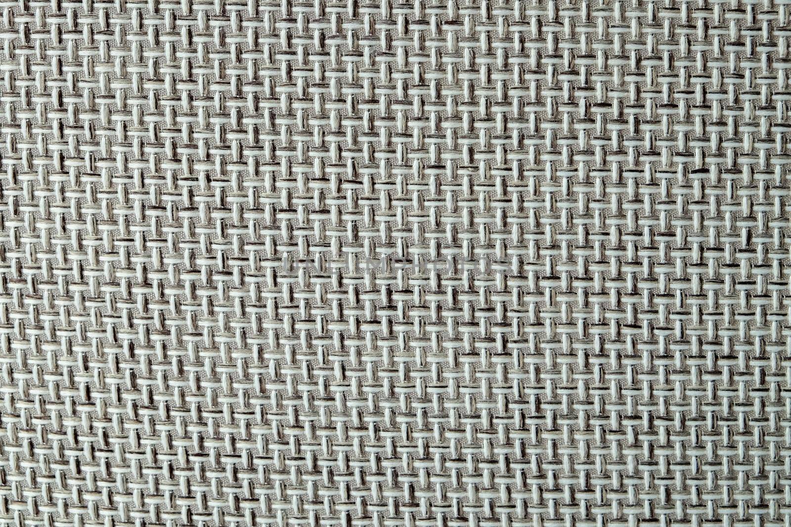 Close-up of a textured fabric. Macro shot of gray upholstery for furniture. Wallpaper and background. Closeup grey fabric texture. Thick gray material for the interior.