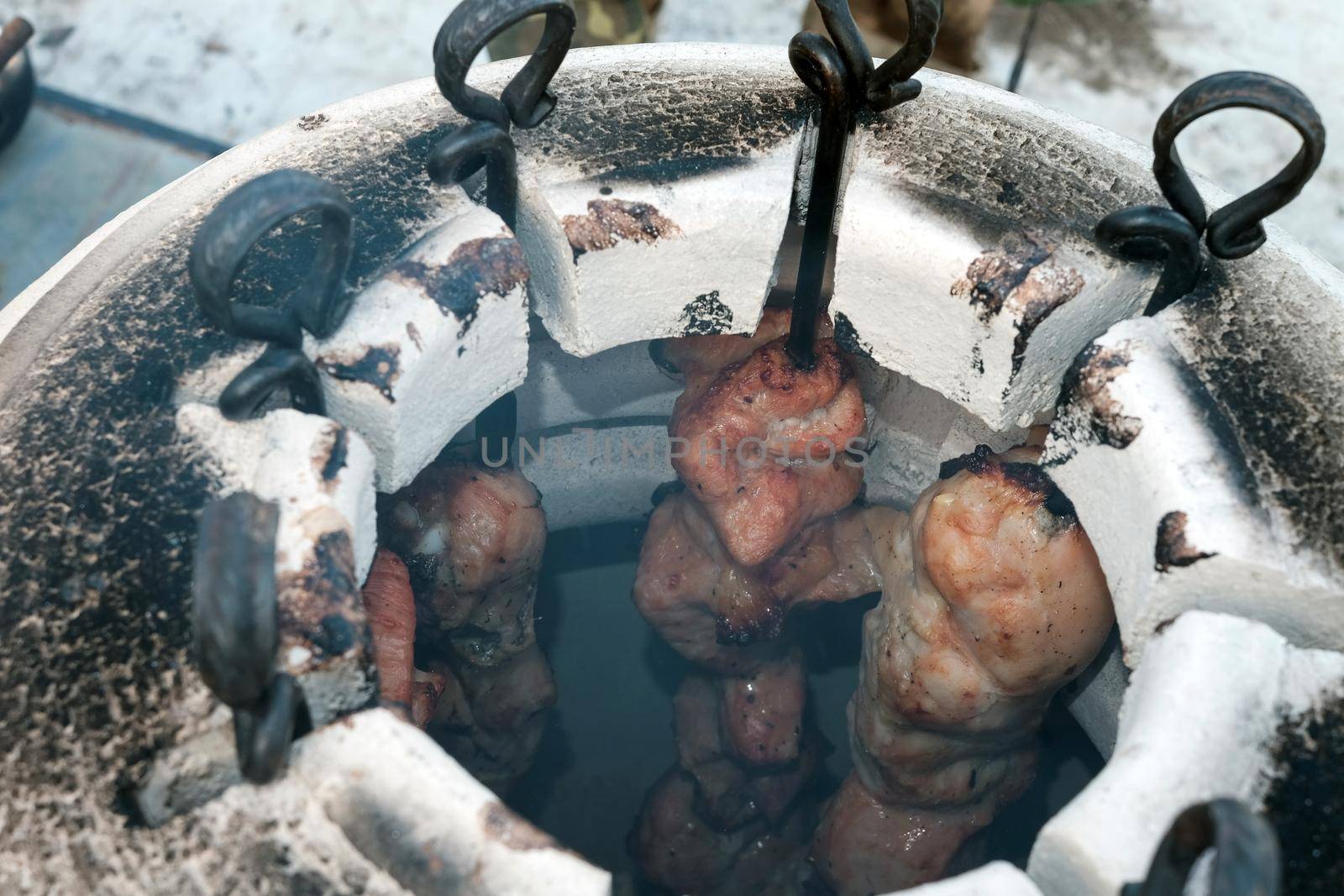 Skewers in the tandoor. Cooking kebab of meat in a tandoor.