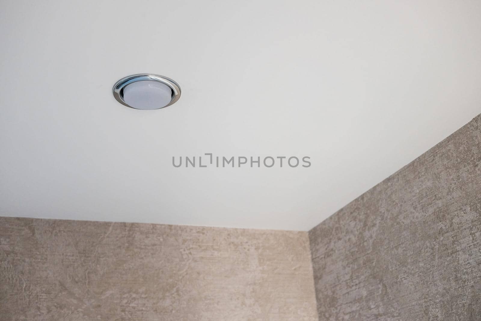 Chrome soffit in white ceiling with brown walls with copy space.