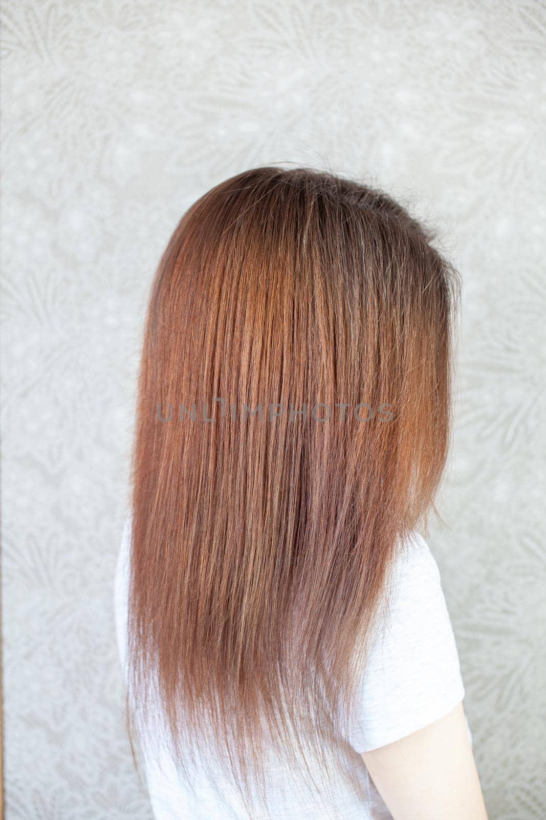 A girl with long, straight and beautiful brown hair. Hair care at home by AnatoliiFoto