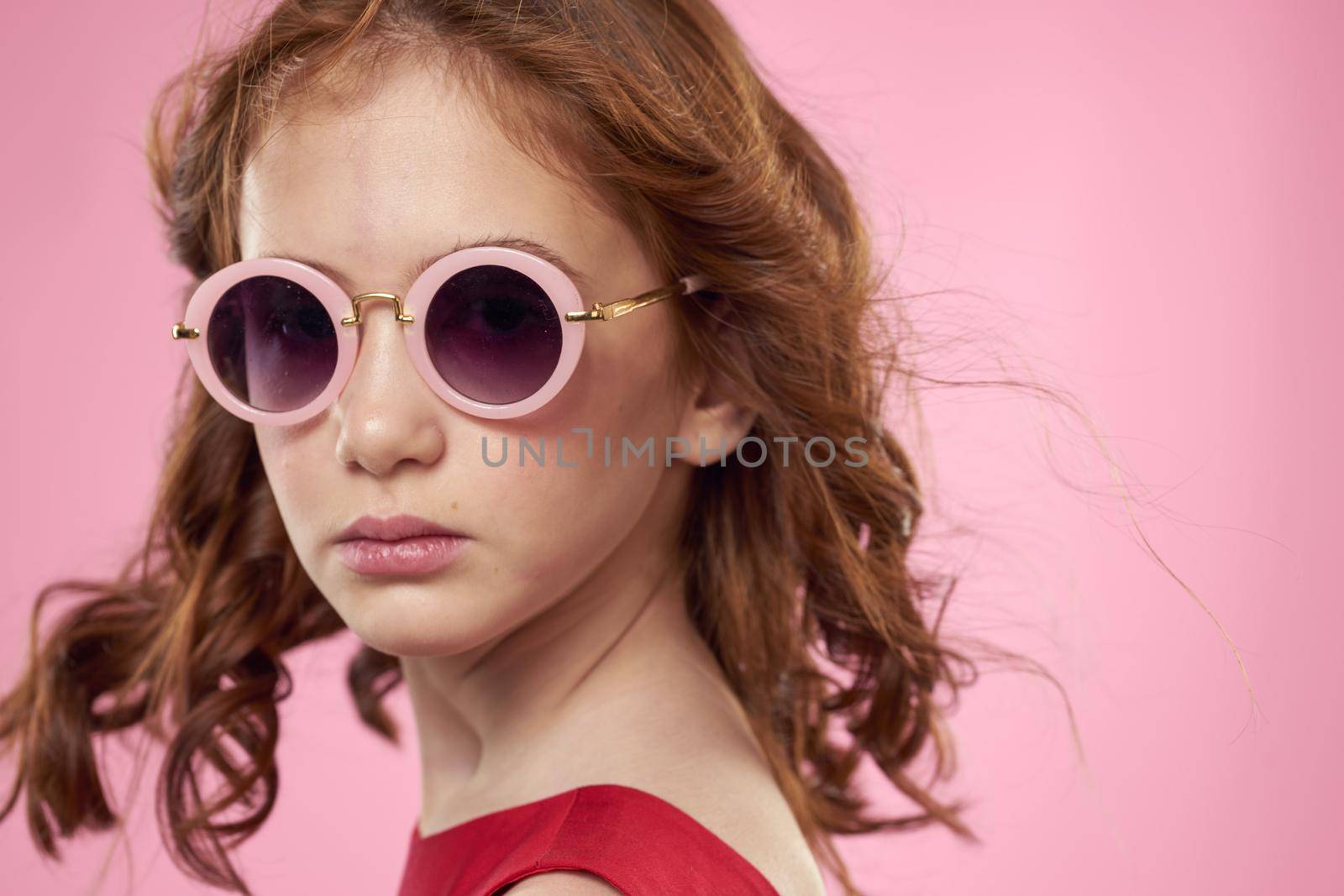 girl with curly hair sunglasses childhood joy pink background by SHOTPRIME