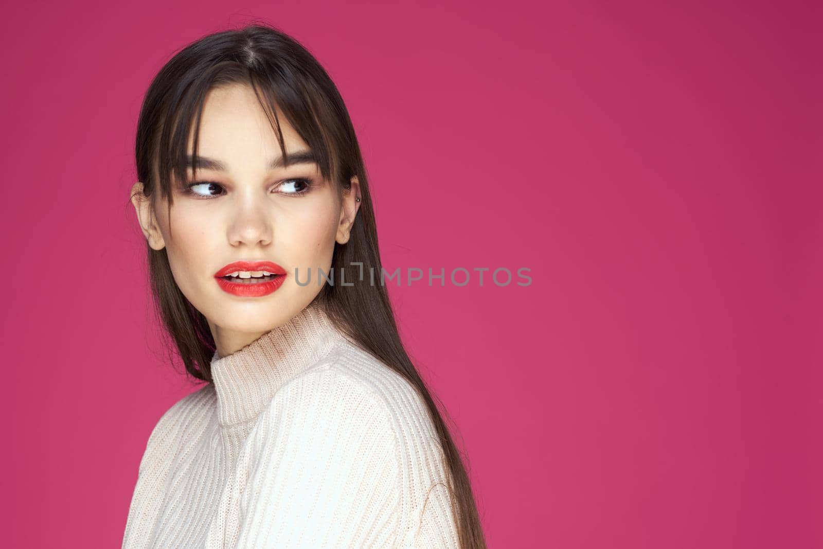 Woman with long hair and red lips white blouse pink background attractive look by SHOTPRIME