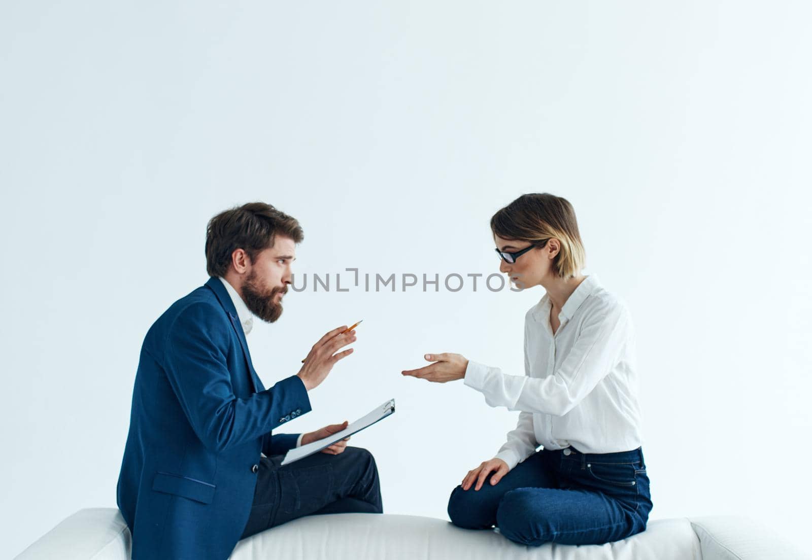 Business men and women sit on the couch communicating employees by SHOTPRIME