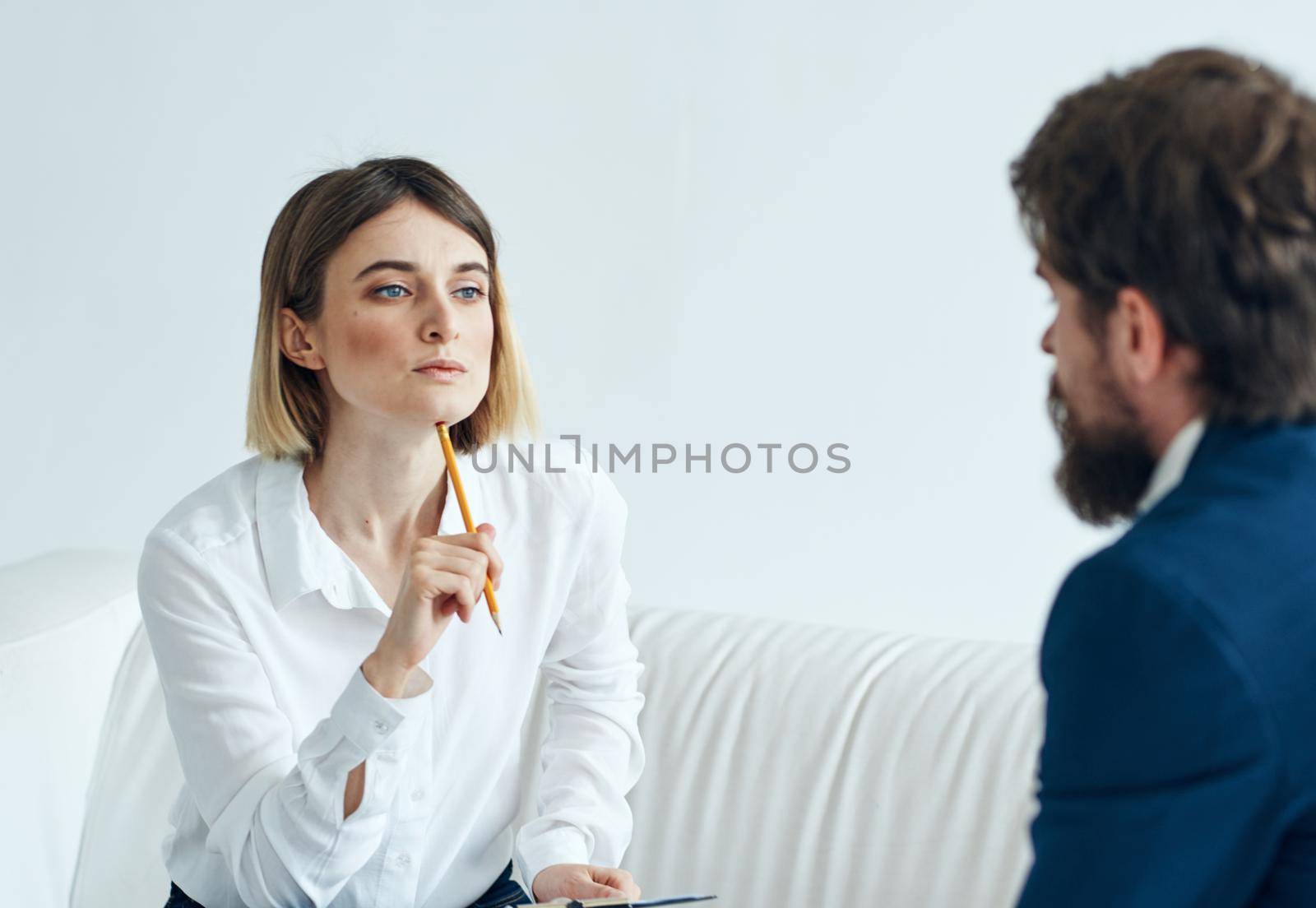 Woman on the couch and doing a man in a suit Communicating mutual understanding work. High quality photo