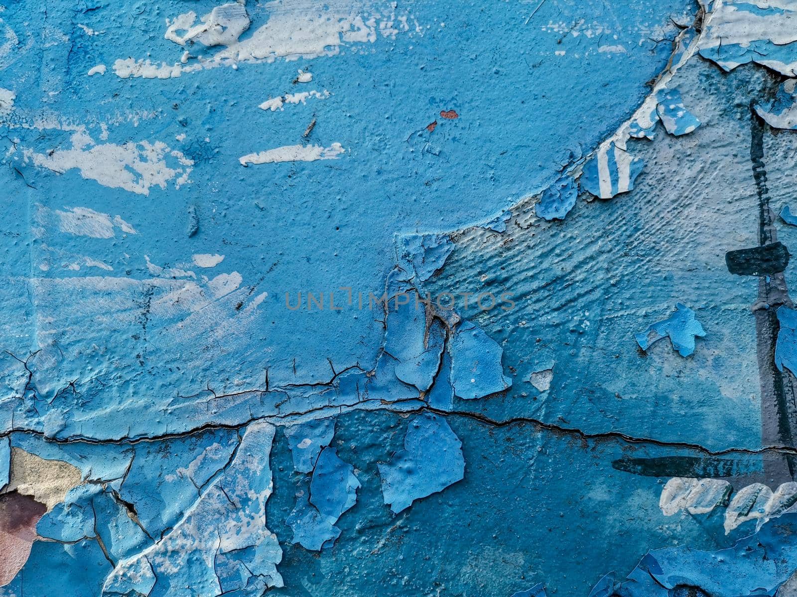 Blue background with cracked oil paint on plaster. For design and networking.