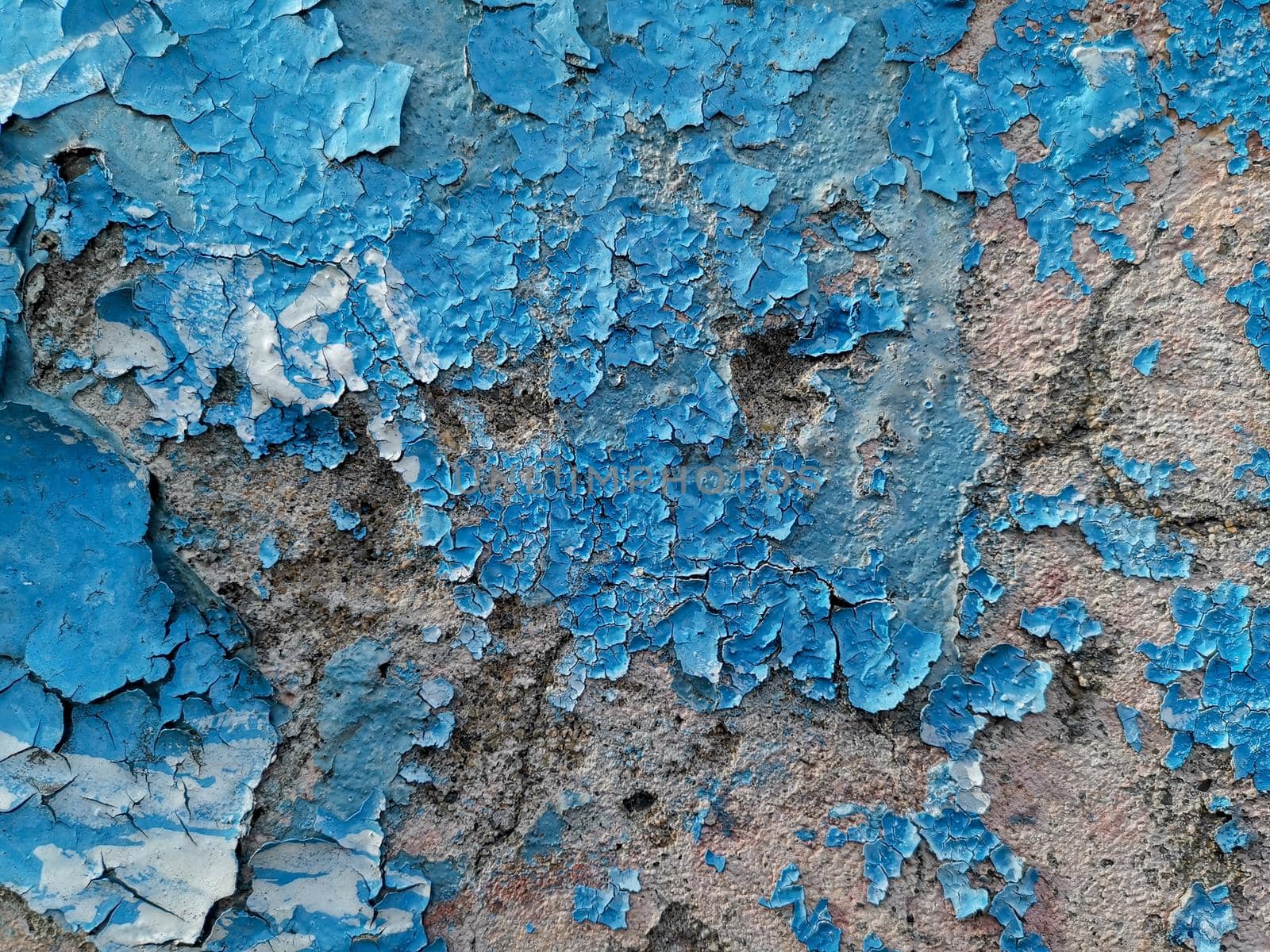 Blue background with cracked oil paint on plaster. For design and networking.