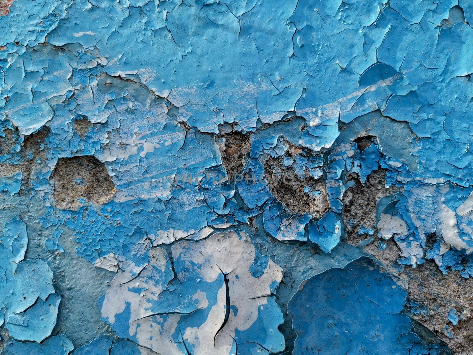 Blue background with cracked oil paint on plaster. For design and networking.