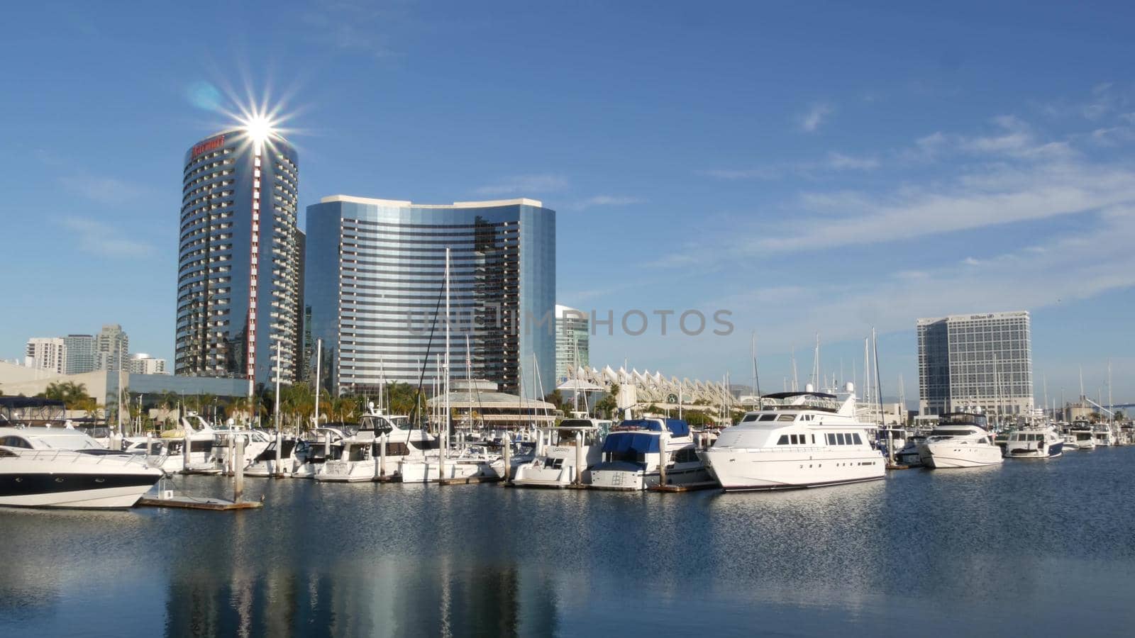 SAN DIEGO, CALIFORNIA USA - 13 FEB 2020: Embarcadero marina park near USS Midway and Convention Center. Marriott hotel near Seaport Village. Luxury yachts, highrise skyscrapers of urban skyline.