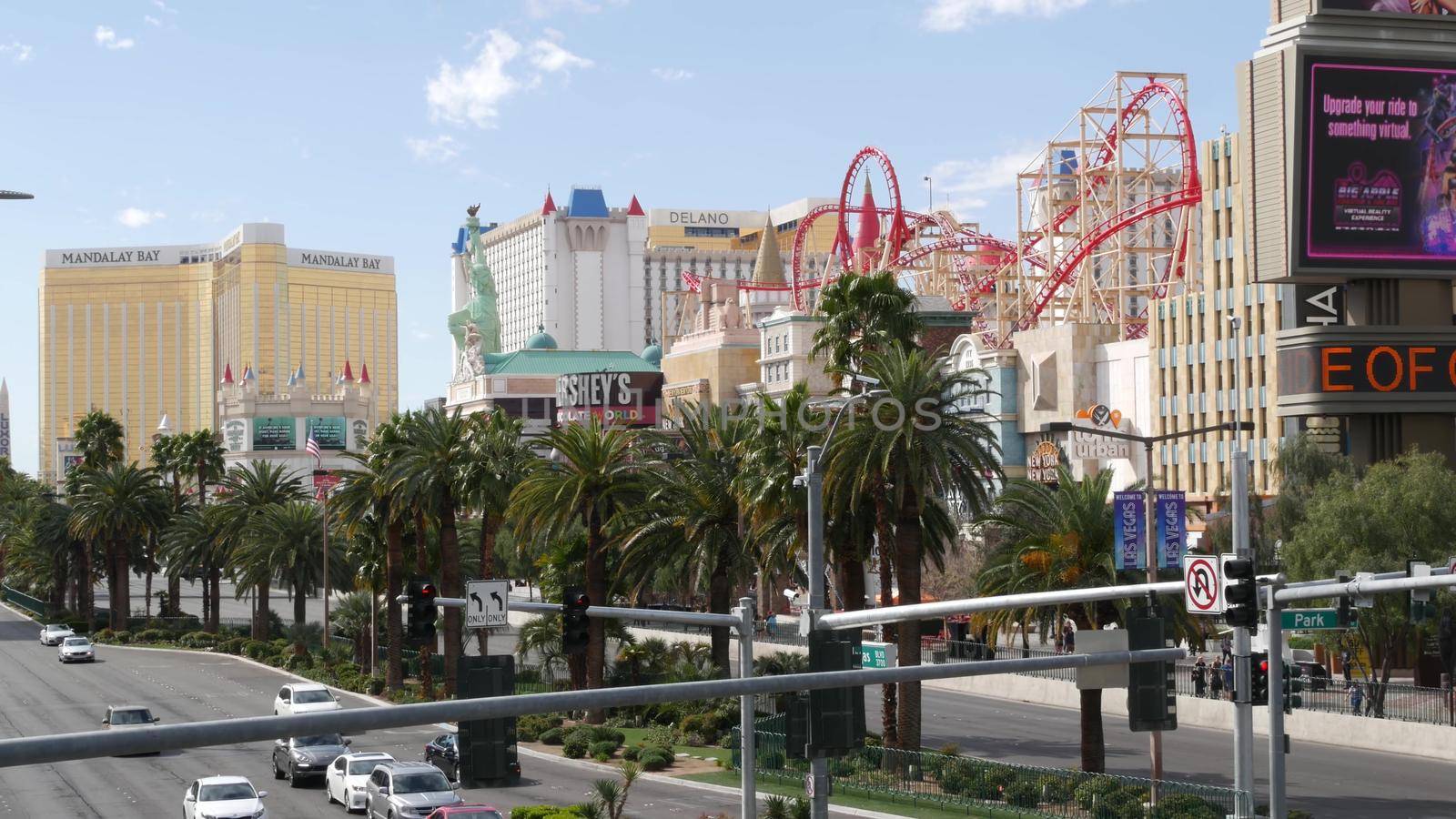 LAS VEGAS, NEVADA USA - 7 MAR 2020: The Strip boulevard with luxury casino in gambling sin city. Car traffic on road to Fremont street, tourist money playing resort. New York hotel and Liberty Statue.