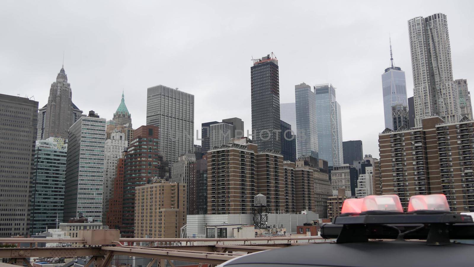 NEW YORK CITY, USA - 12 MAR 2020: Emergency siren glowing, 991 police patrol car on Brooklyn bridge. NYPD auto, symbol of crime prevention and safety in Manhattan. Metropolis security and protection by DogoraSun