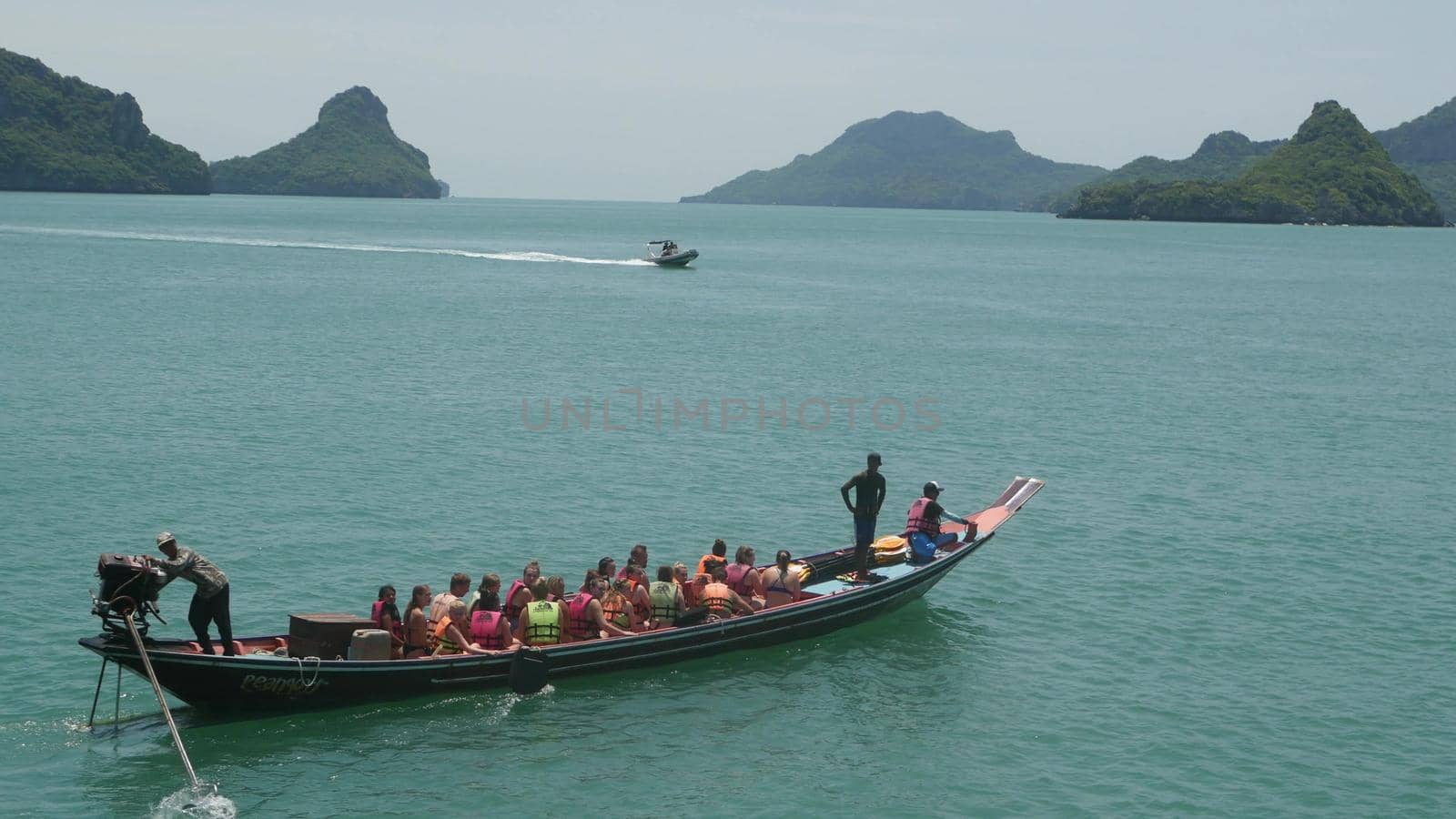ANG THONG MARINE PARK, SAMUI, THAILAND - 9 JUNE 2019: Group of Islands in ocean near touristic paradise tropical resort. Idyllic turquoise sea with boat with tourists. Travel vacation holiday concept by DogoraSun