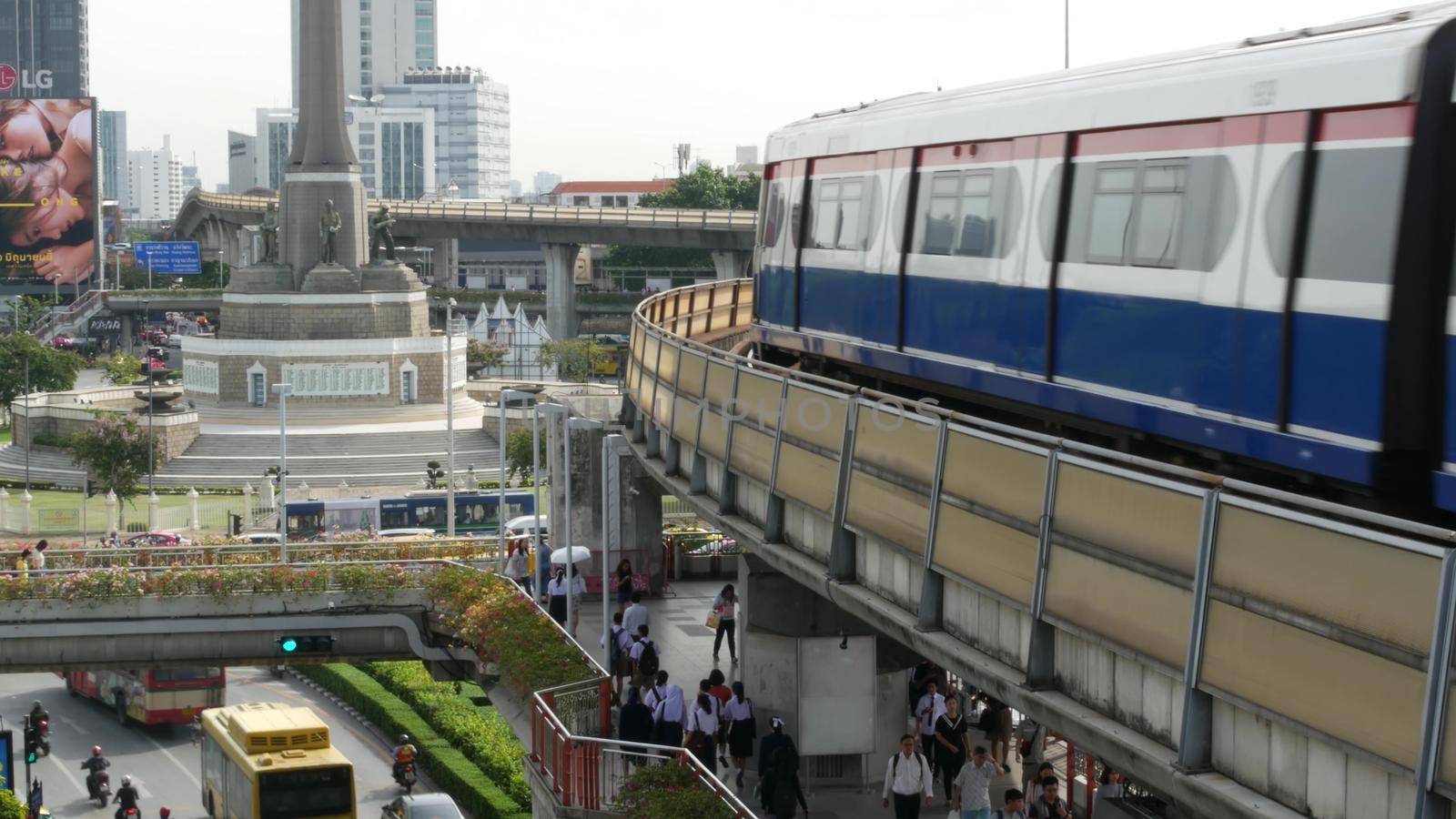 BANGKOK, THAILAND - 10 JULY, 2019: Rush hour traffic near Victory Monumet in Krungthep capital. Famous asian landmark and travel destination. Downtown modern city life. People and passengers of bts