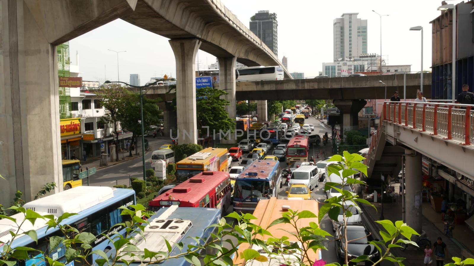 BANGKOK, THAILAND - 10 JULY, 2019: Rush hour traffic near Victory Monumet in Krungthep capital. Famous asian landmark and travel destination. Downtown modern city life. People and passengers of bts. by DogoraSun